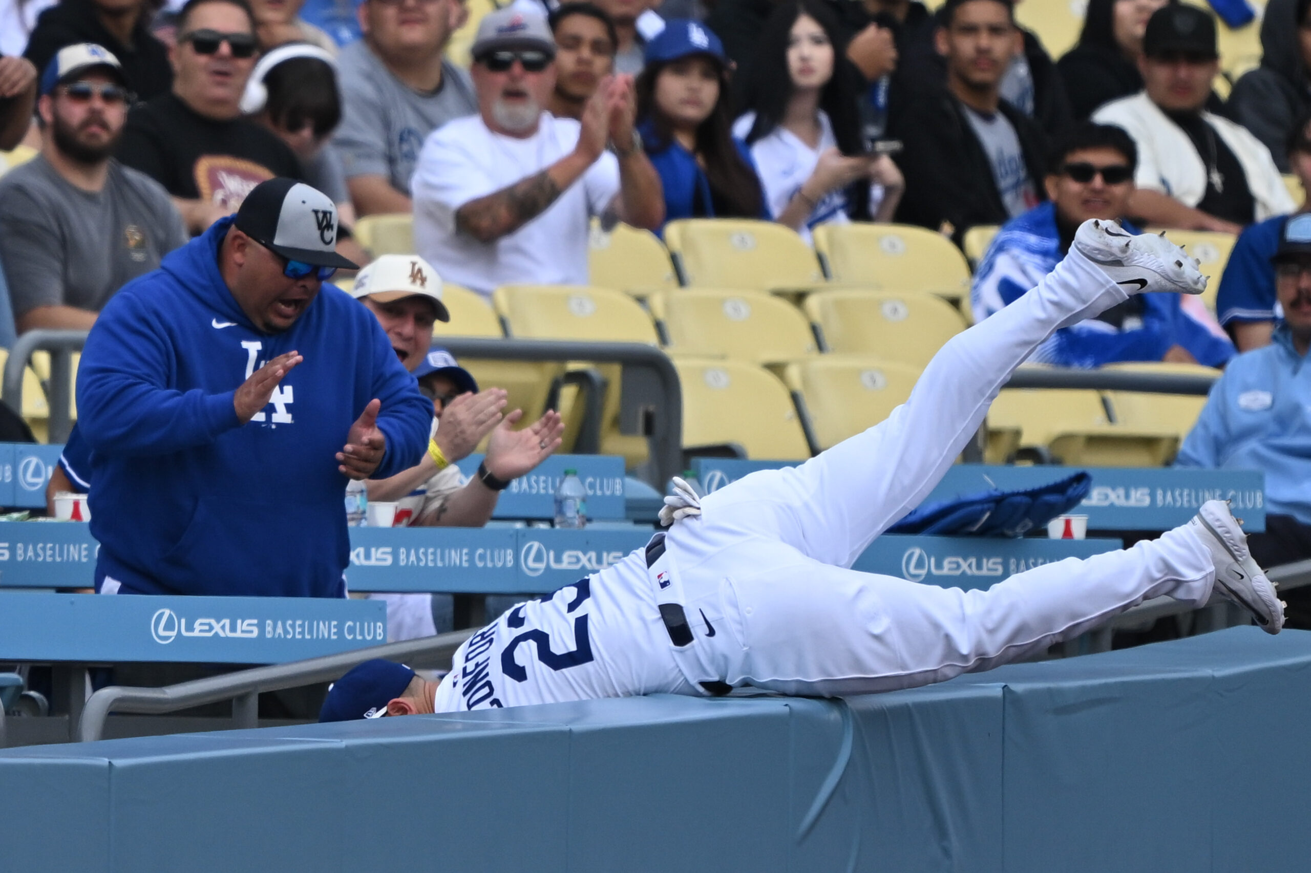 Dodgers left fielder Michael Conforto tumbles into the stands after...