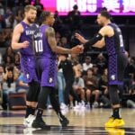 Sacramento Kings forward DeMar DeRozan (10) talks with forward Domantas Sabonis (left) and guard Zach LaVine