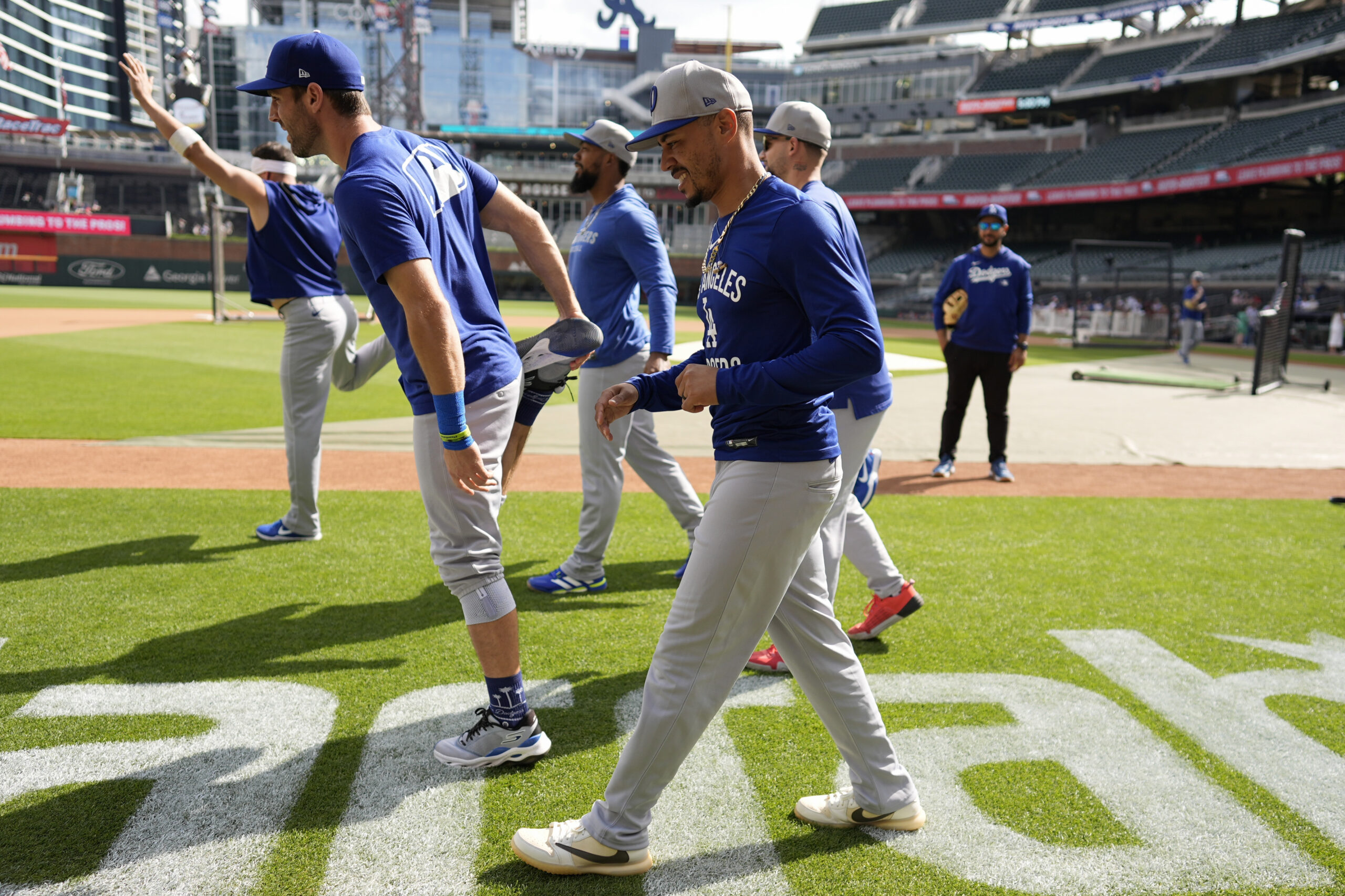 Dodgers shortstop Mookie Betts, right, and teammates warm up before...