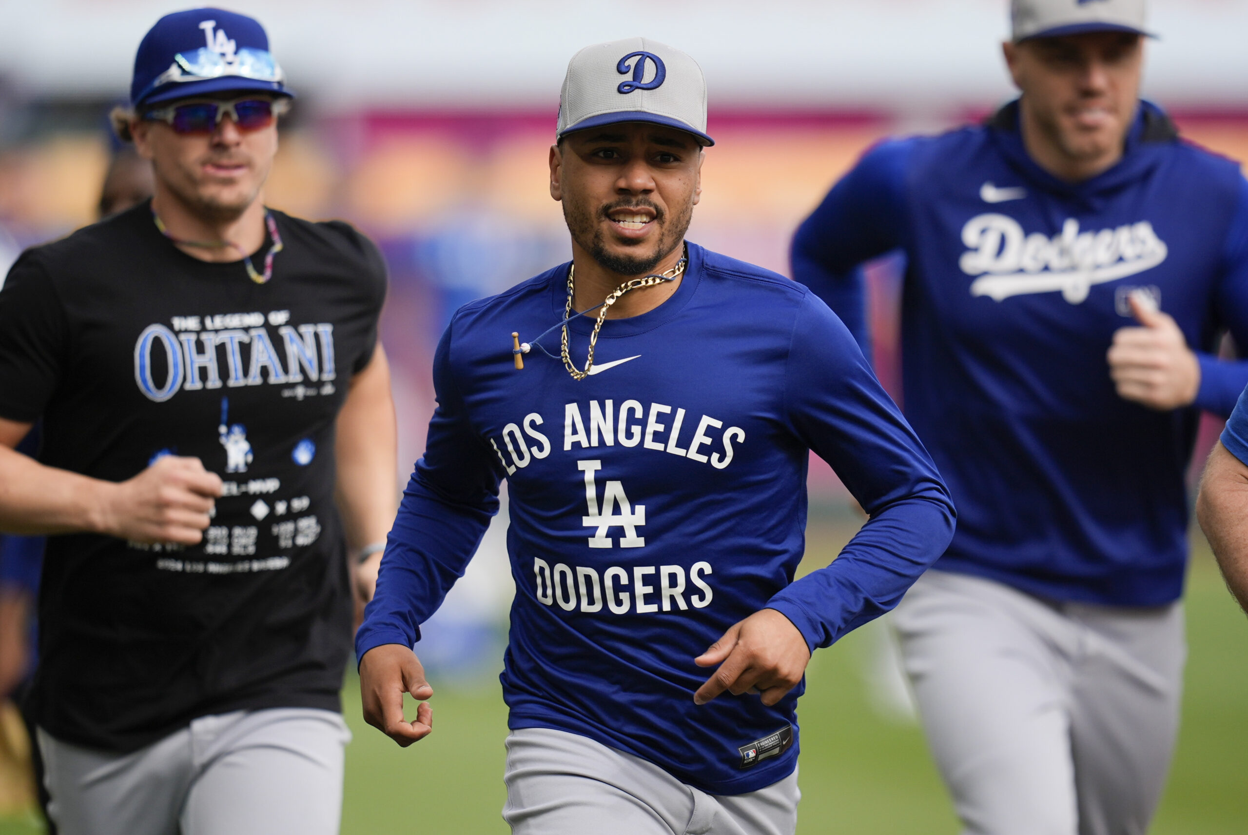 Dodgers shortstop Mookie Betts, center, warms up with teammates before...