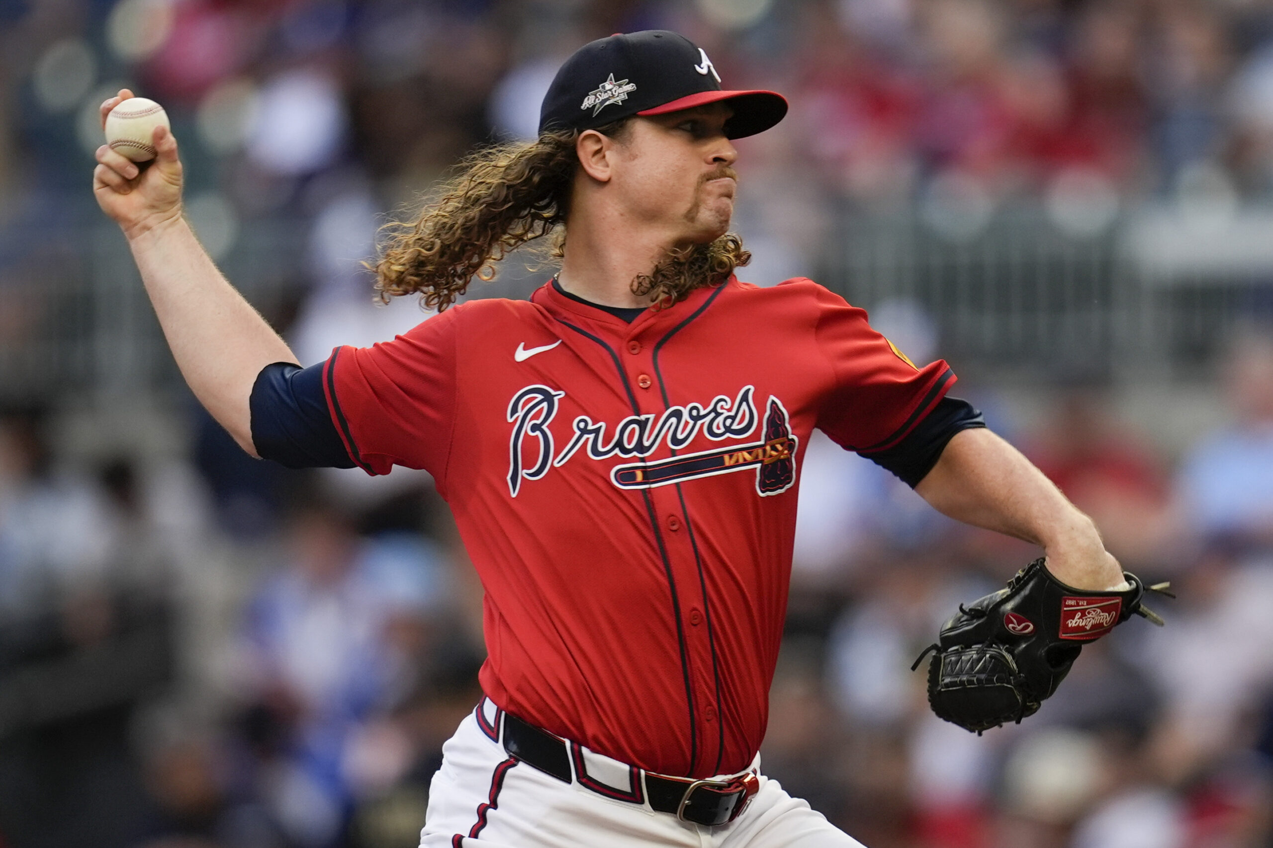 Atlanta Braves starting pitcher Grant Holmes throws to the plate...