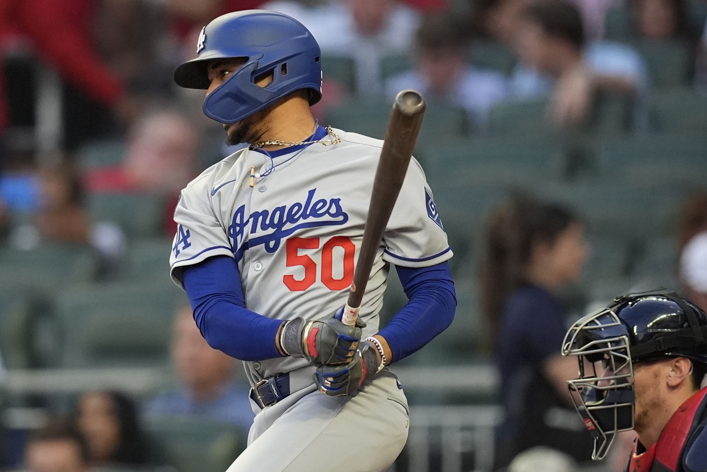 The Dodgers’ Mookie Betts hits a single against the Atlanta...