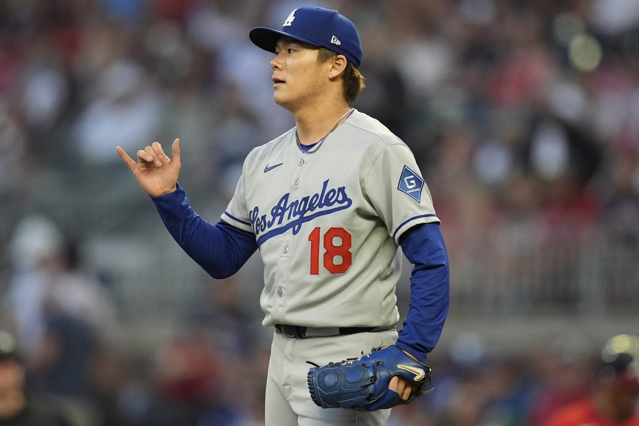 Dodgers starting pitcher Yoshinobu Yamamoto reacts in the fourth inning...