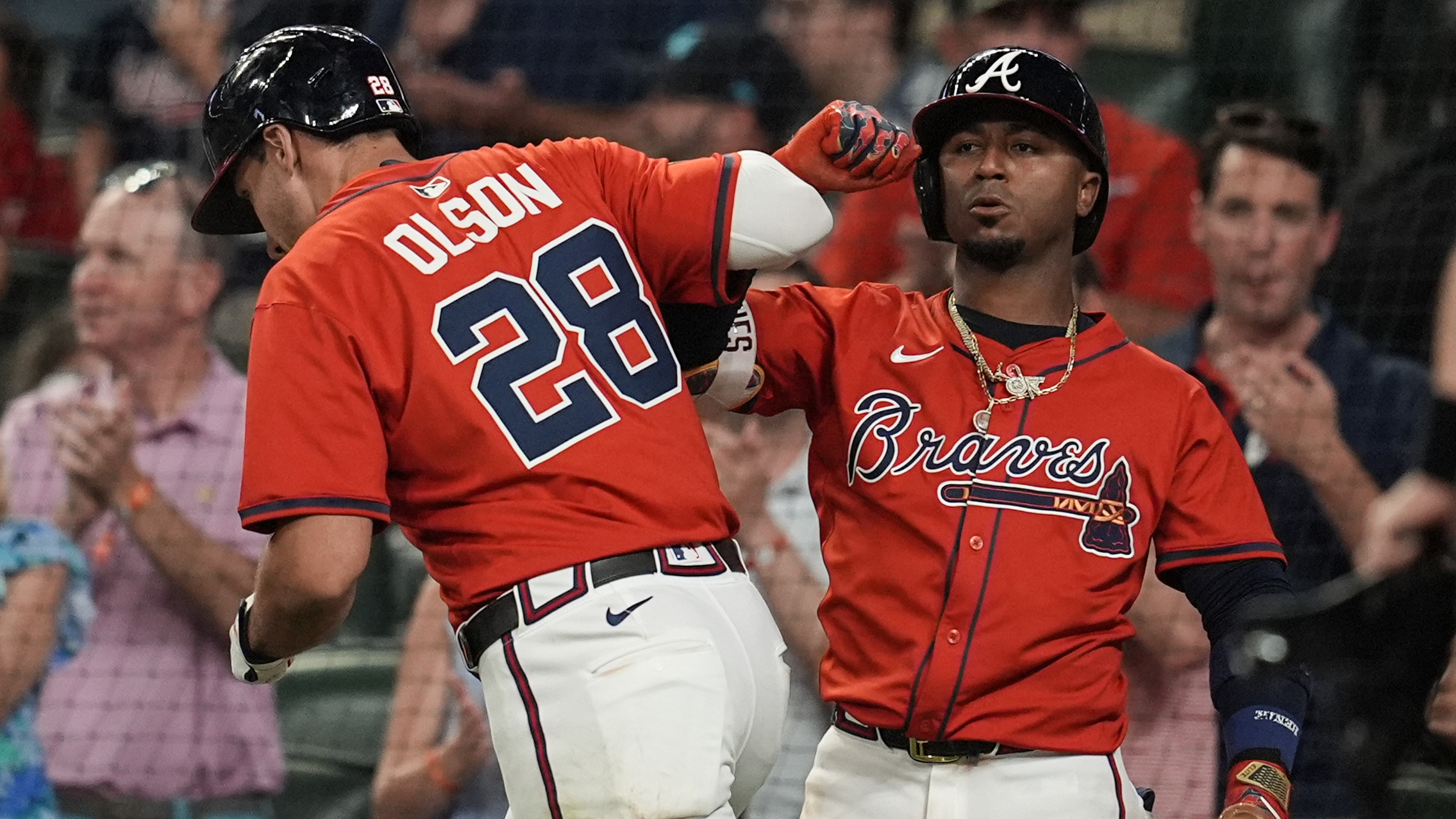 The Atlanta Braves’ Matt Olson, left, celebrates his solo homer...