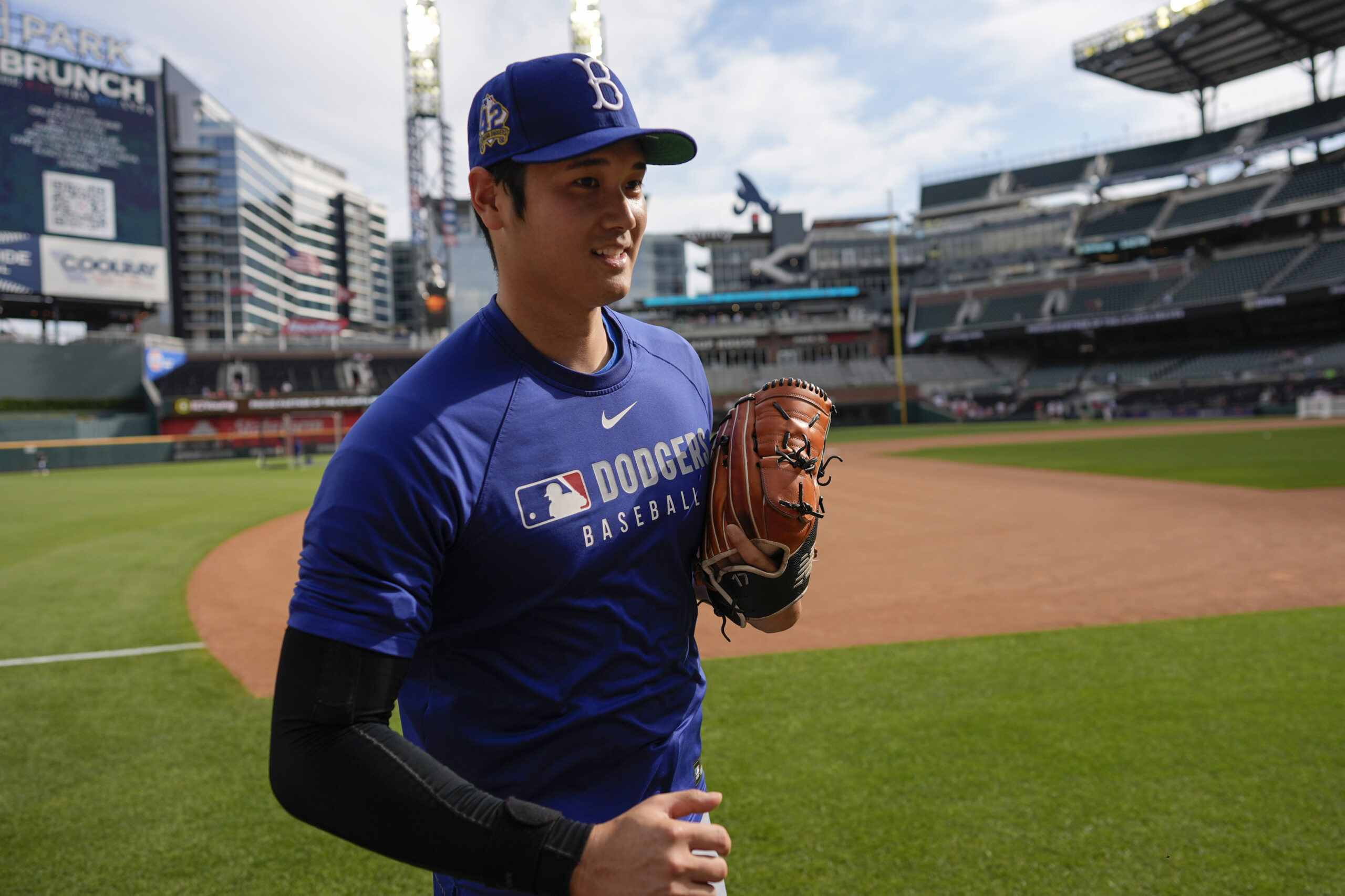 Dodgers star Shohei Ohtani warms up before a baseball game...