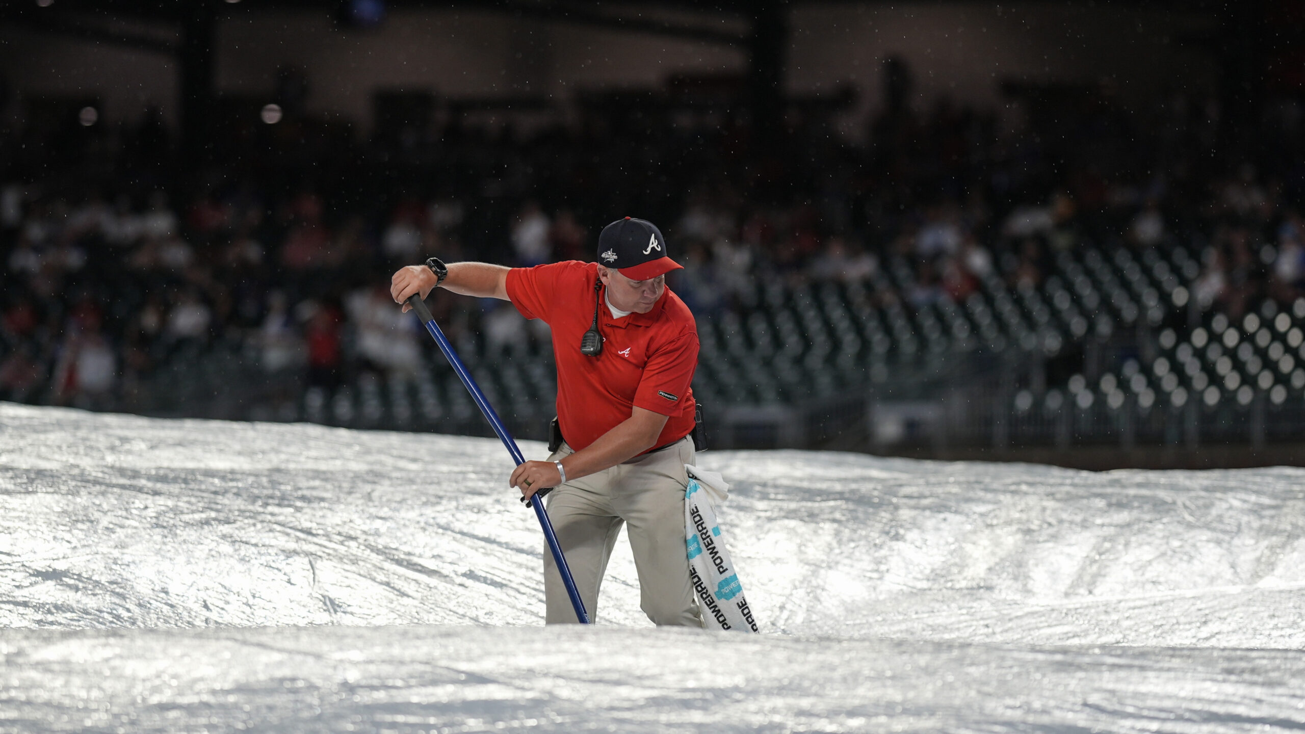 Grounds crew work during a rain delay in the ninth...