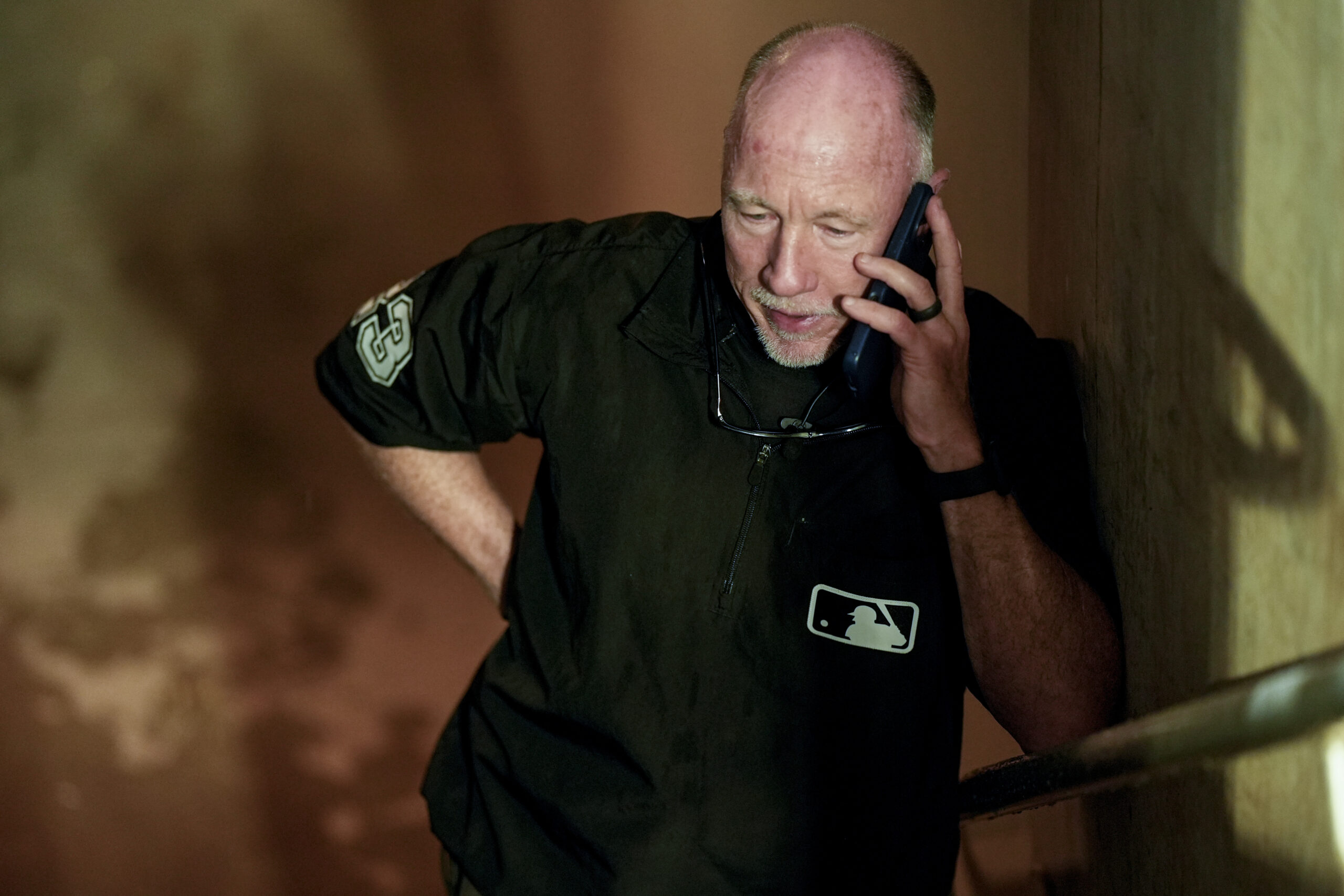 Umpire Will Little speaks on the phone during a rain...