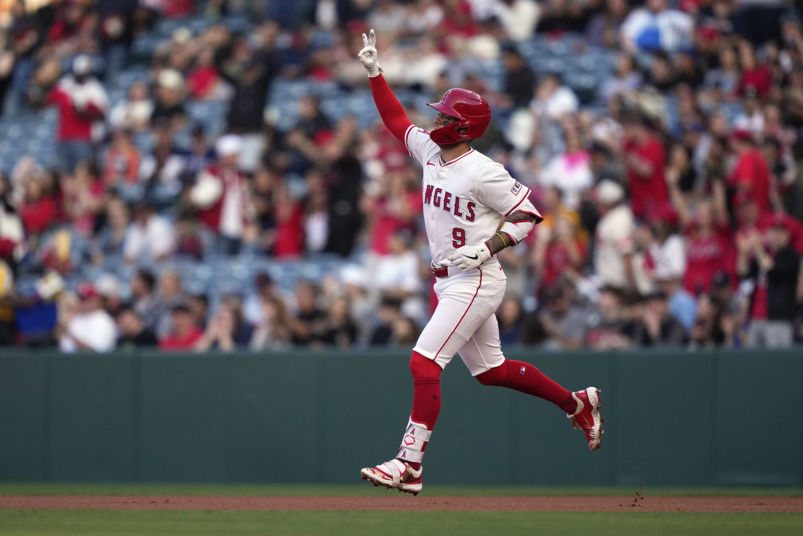 The Angels’ Zach Neto gestures after hitting a solo home...