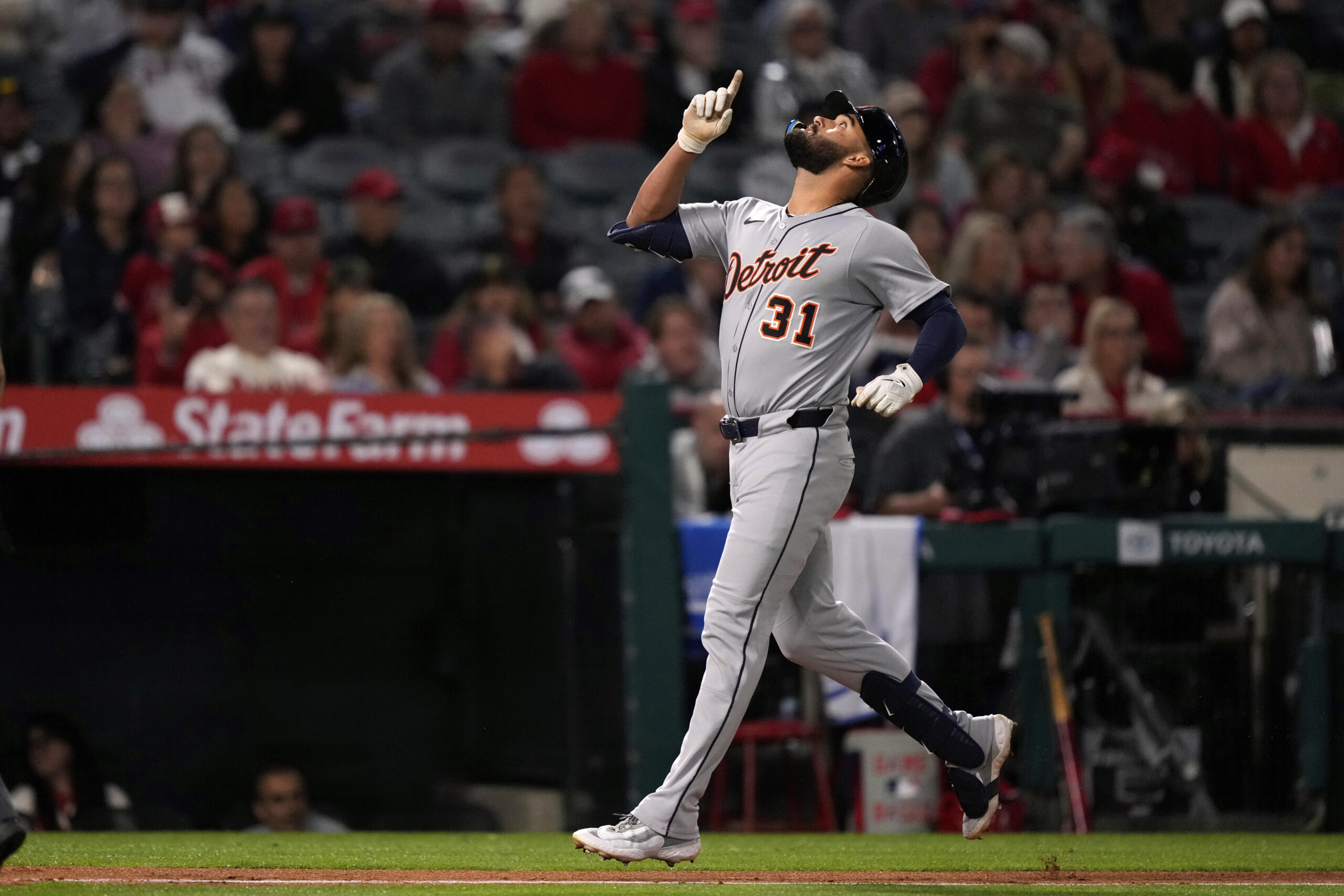 The Detroit Tigers’ Riley Greene gestures as he scores after...