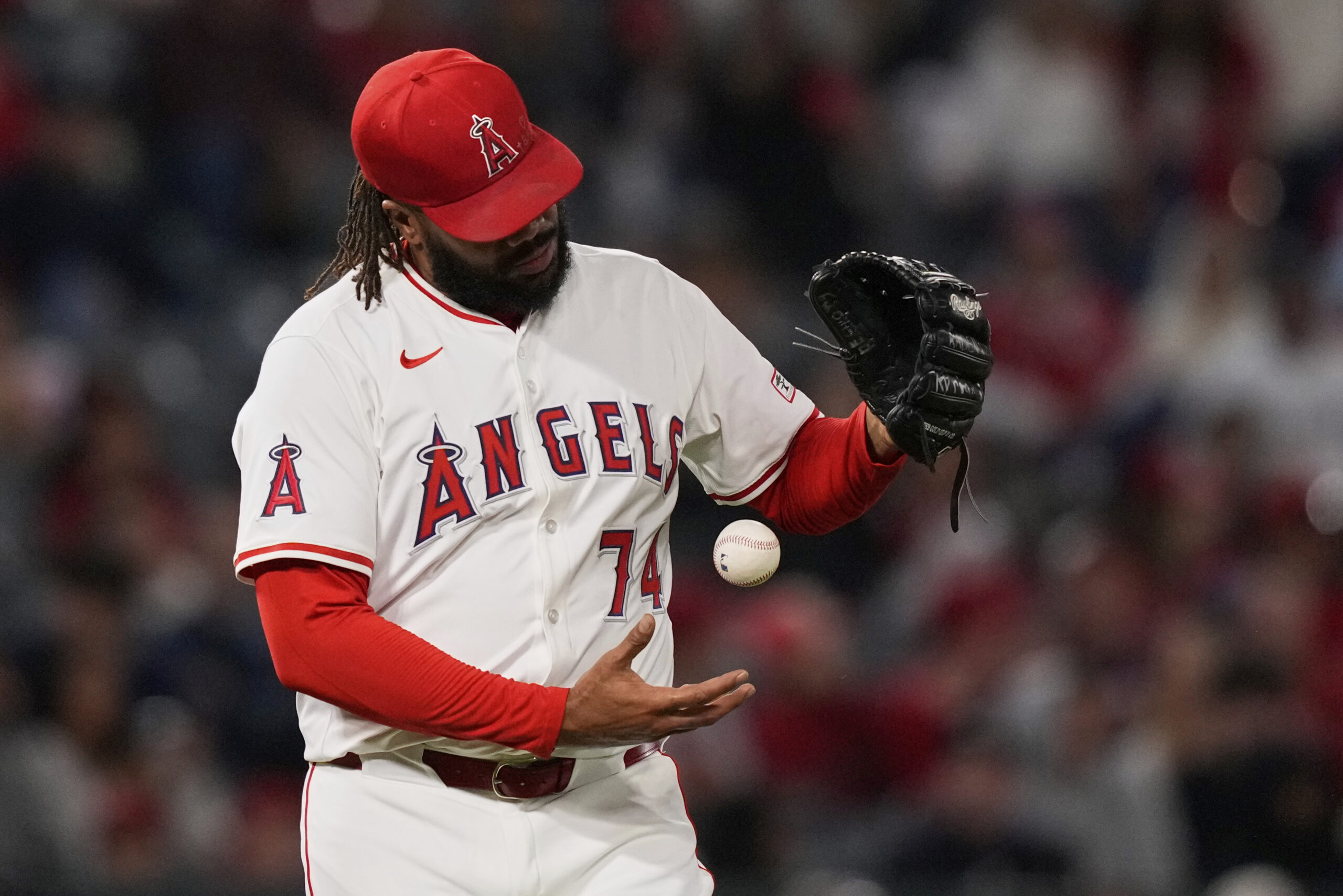 Angels relief pitcher Kenley Jansen tosses a new baseball after...
