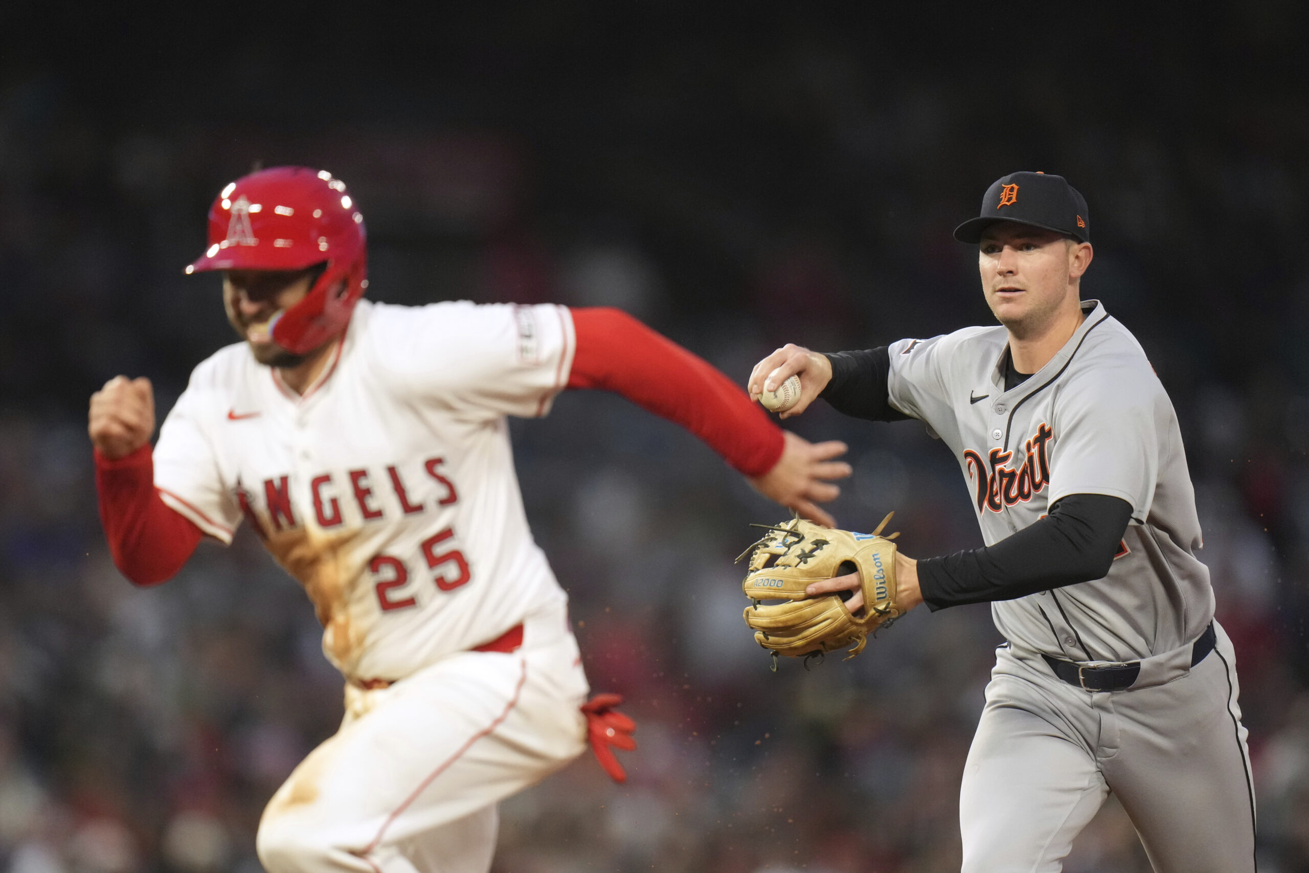 The Angels’ Travis d’Arnaud, left, gets caught in a rundown...