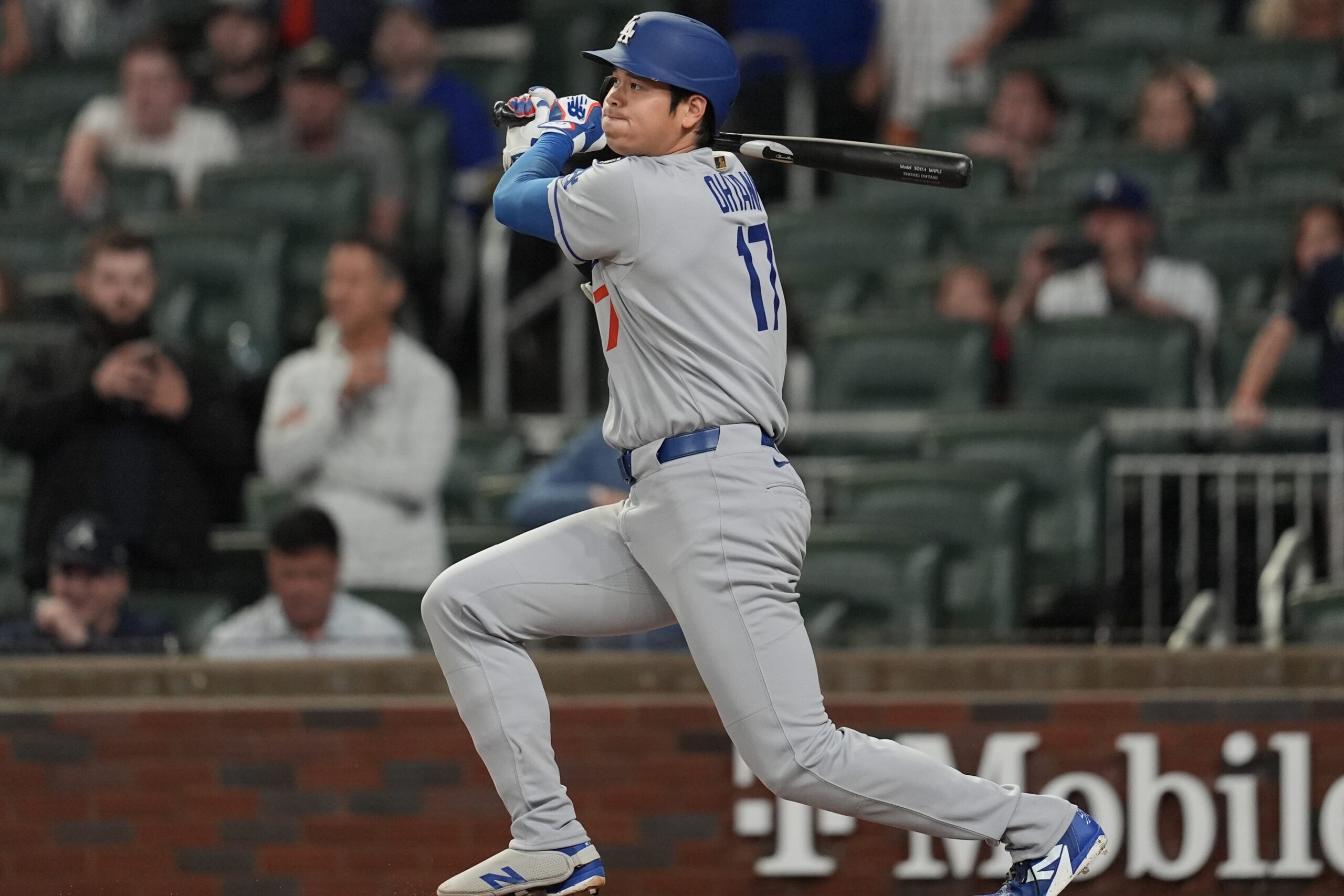 Dodgers star Shohei Ohtani hits a single against the Atlanta...