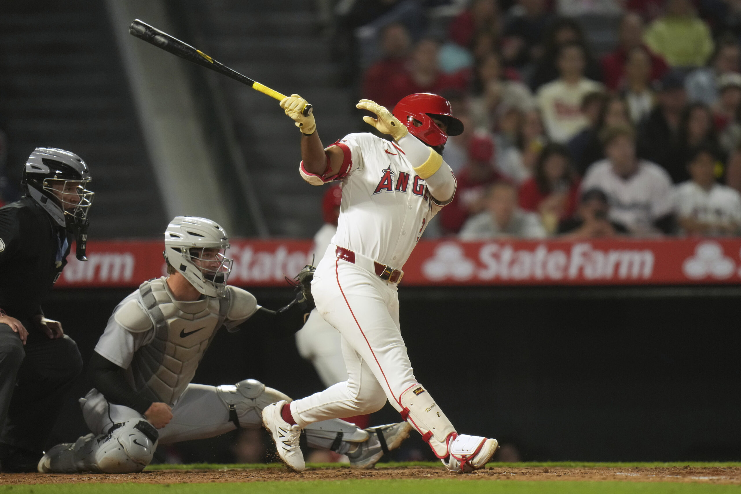 The Angels’ Luis Rengifo follows through after hitting a two-run...