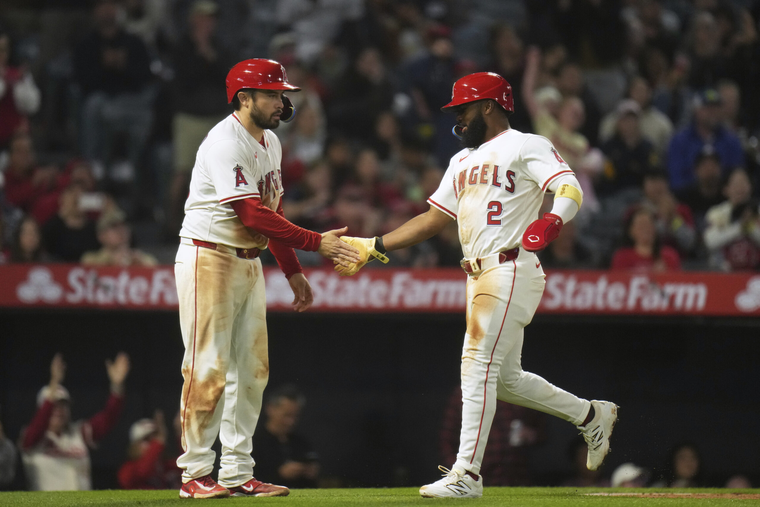 The Angels’ Luis Rengifo, right, and Travis d’Arnaud celebrate after...