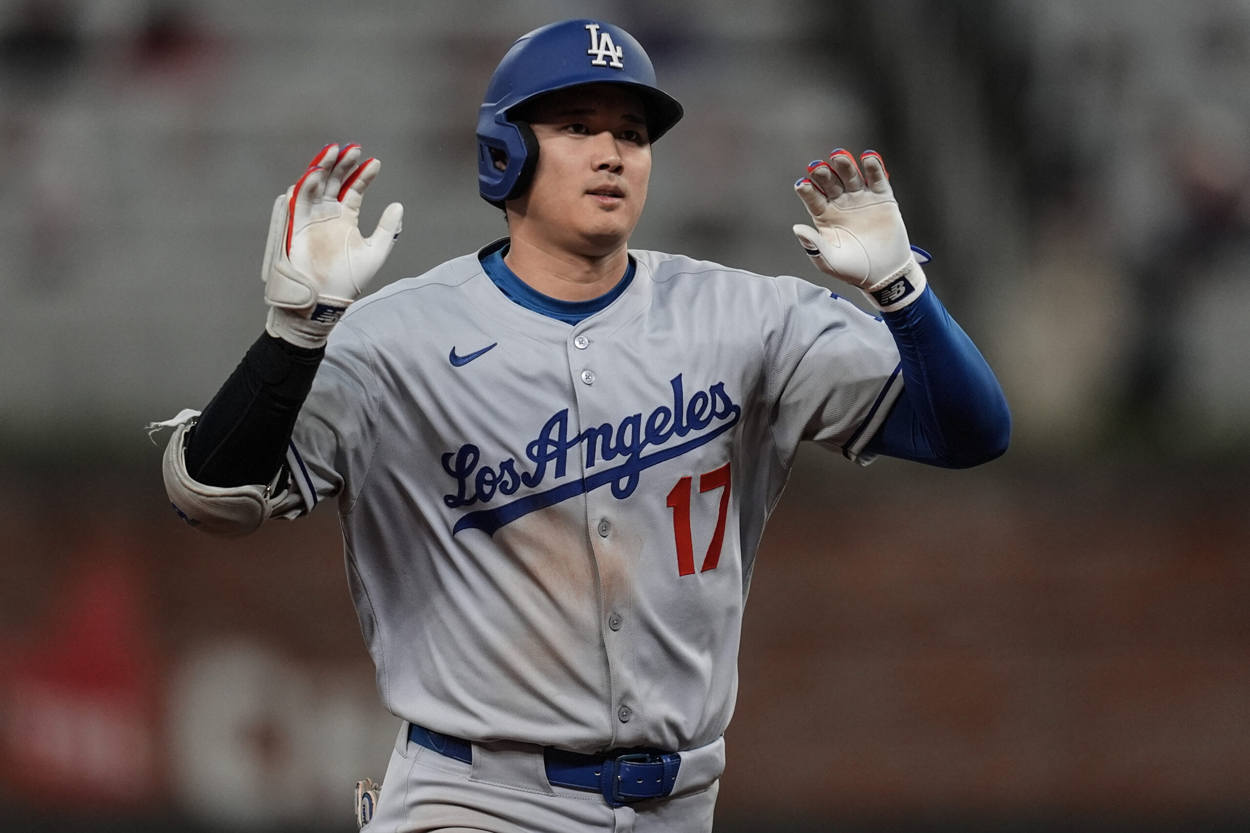 Dodgers star Shohei Ohtani celebrates as he runs the bases...