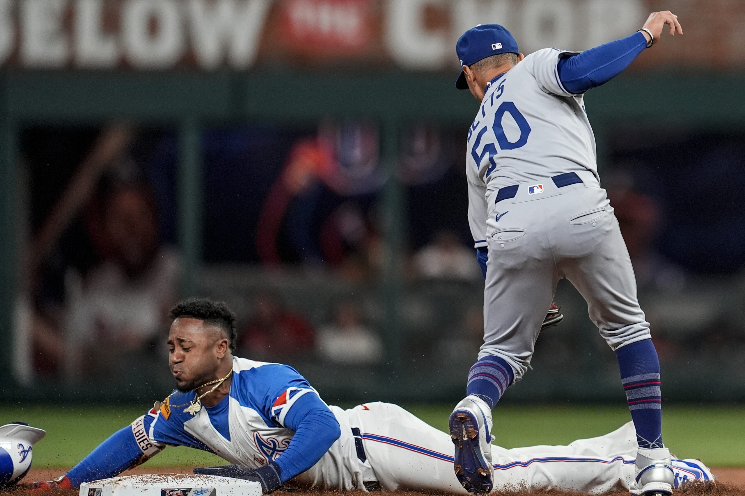 The Atlanta Braves’ Ozzie Albies steals second base in front...