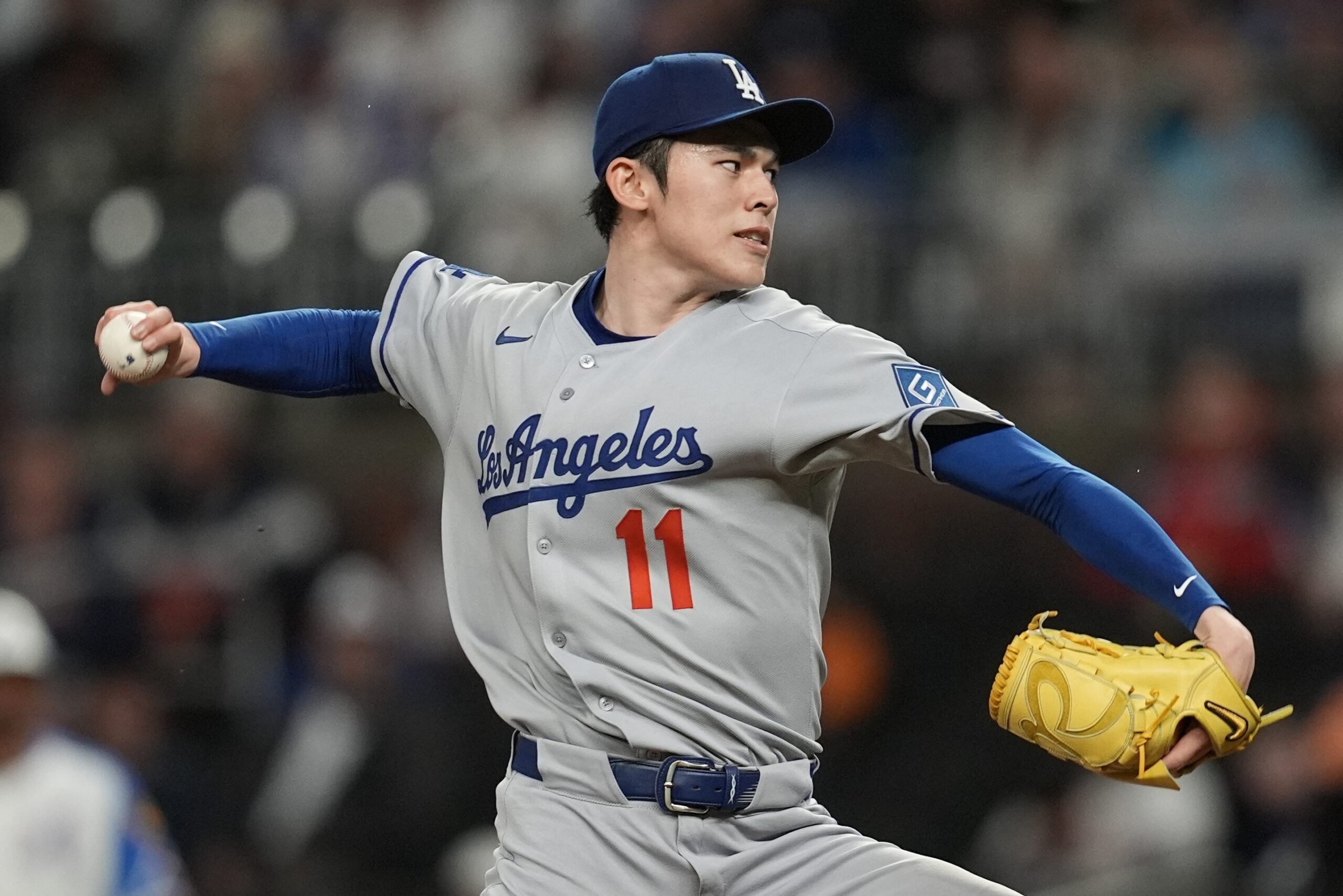 Dodgers starting pitcher Roki Sasaki throws to the plate during...