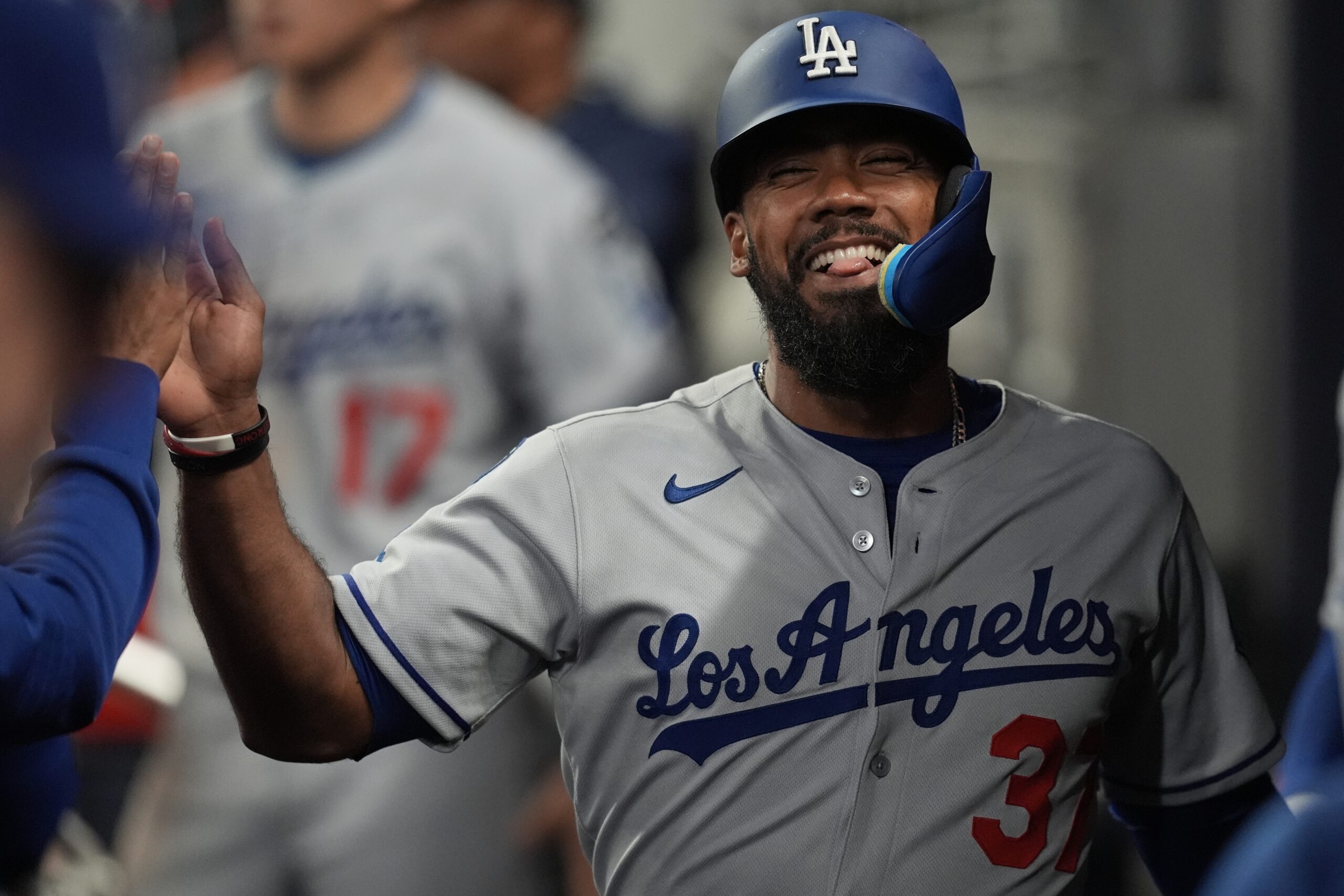 The Dodgers’ Teoscar Hernández celebrates in the dugout after scoring...