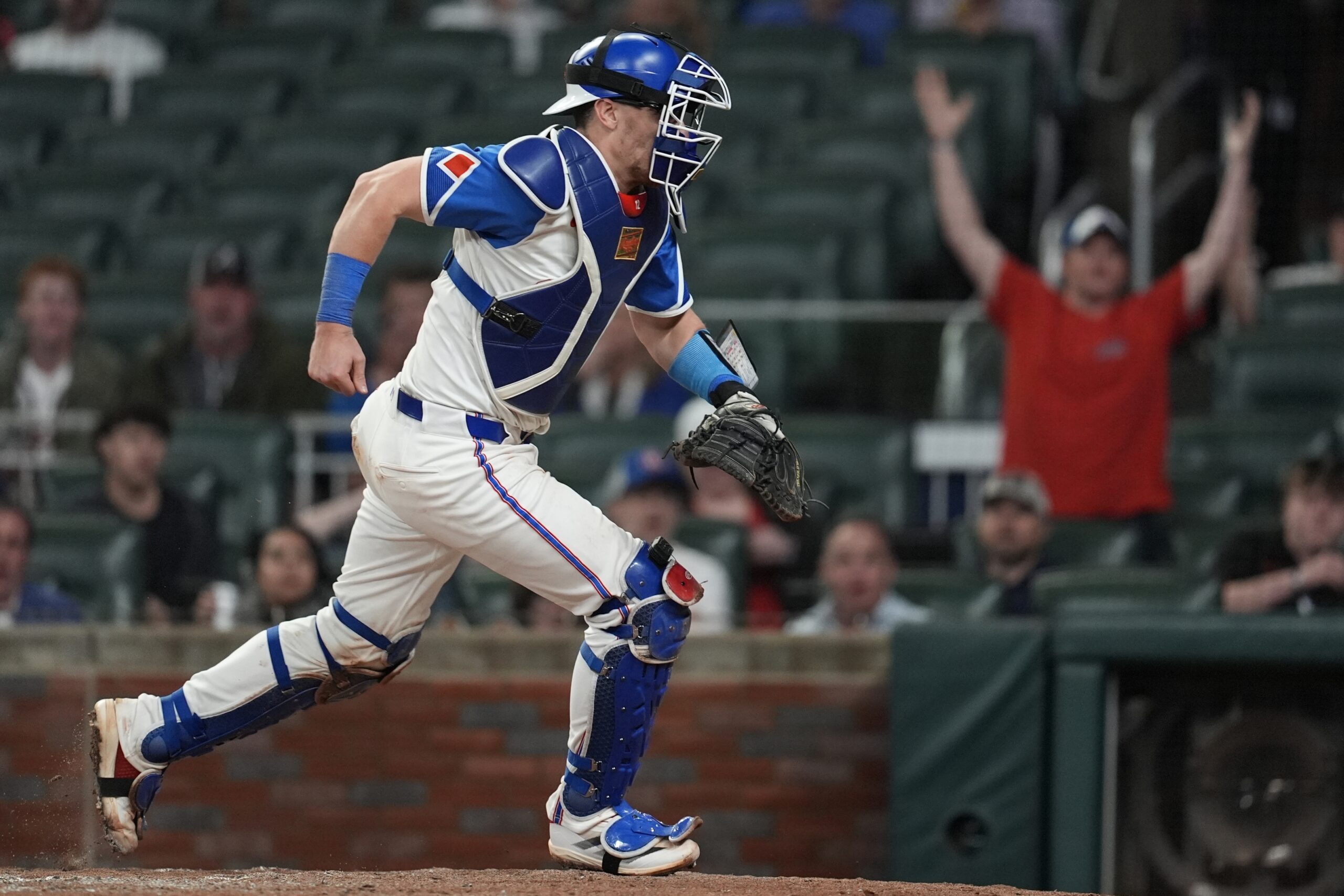Atlanta Braves catcher Sean Murphy runs after a loose ball...
