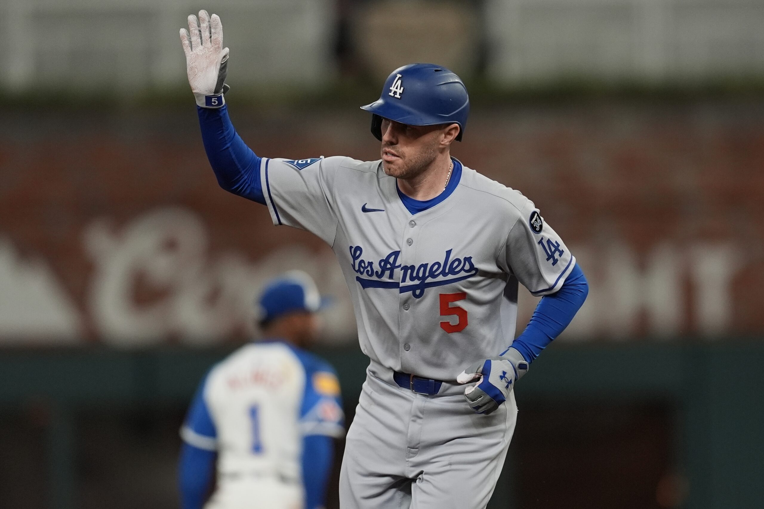 The Dodgers’ Freddie Freeman celebrates as he runs the bases...