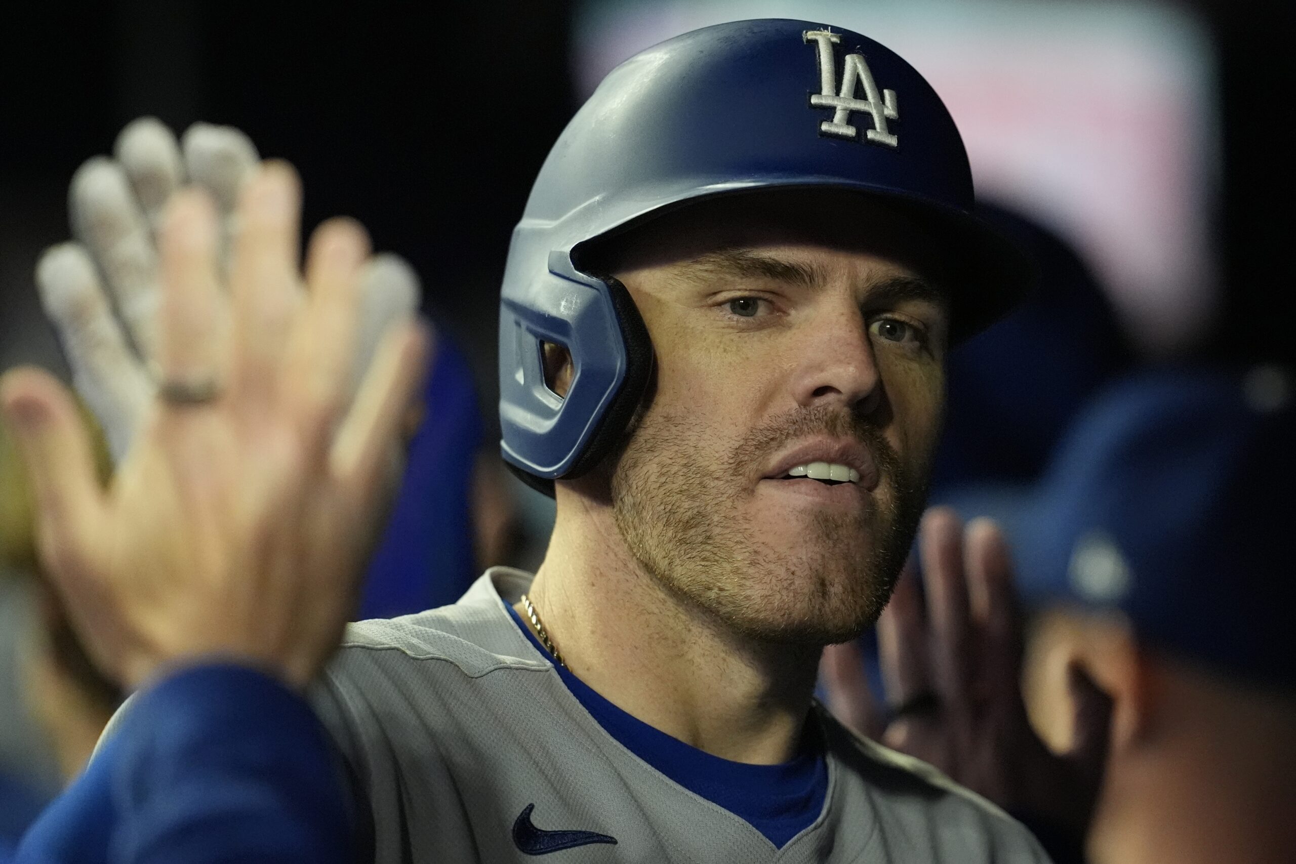 The Dodgers’ Freddie Freeman celebrates in the dugout after hitting...