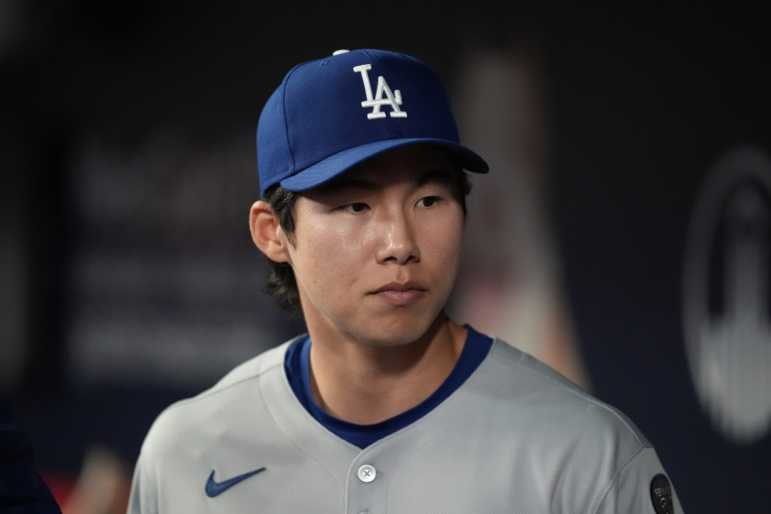Dodgers infielder Hyeseong Kim stands in the dugout in the...