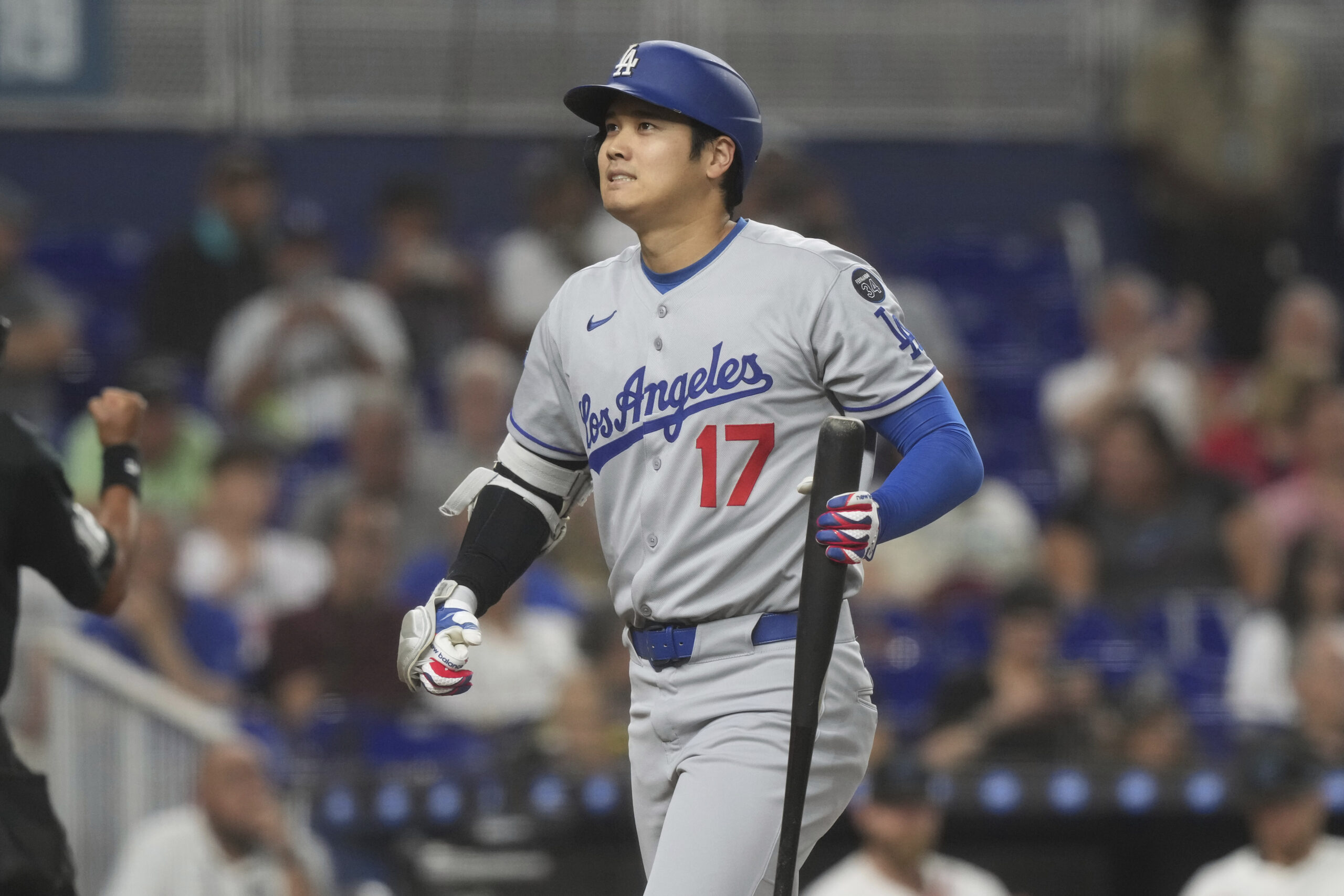 Dodgers star Shohei Ohtani reacts as he walks back to...