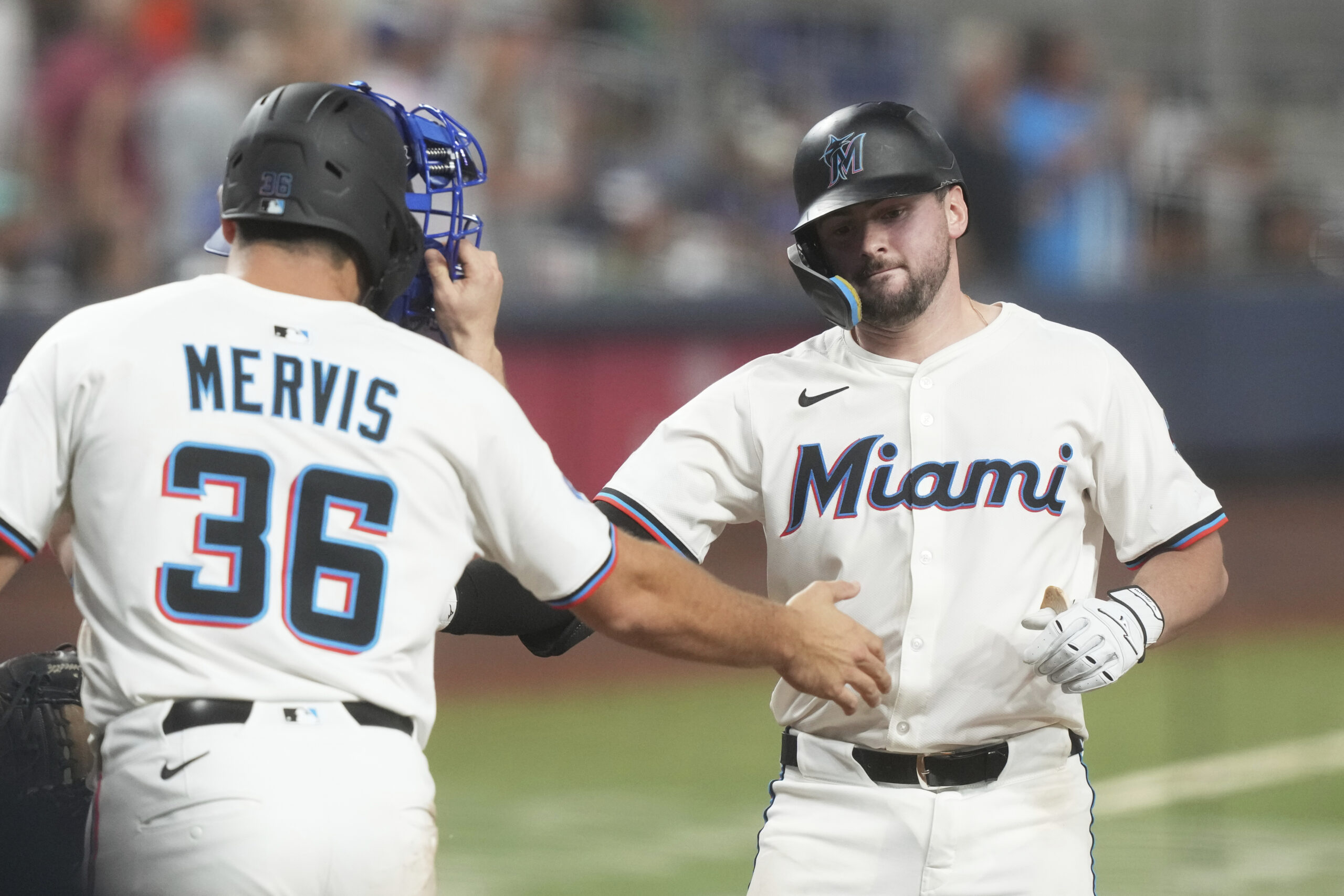 The Miami Marlins’ Liam Hicks, right, celebrates with Miami Marlins...