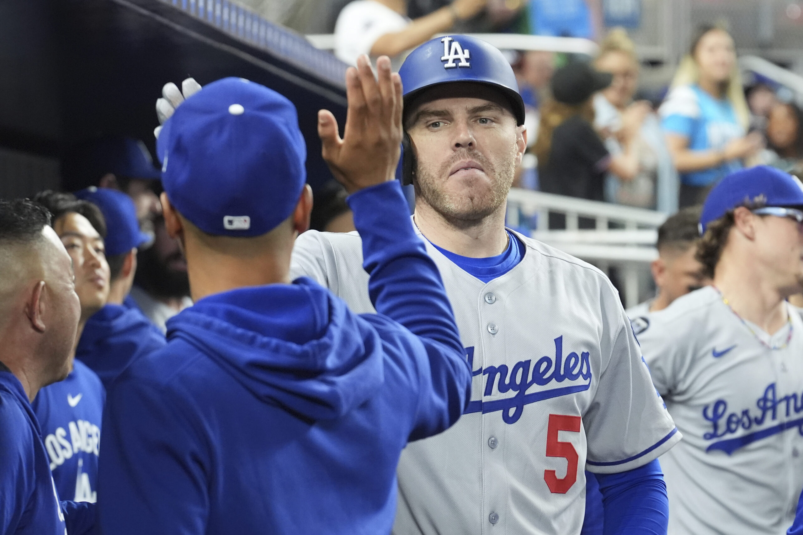 The Dodgers’ Freddie Freeman celebrates in the dugout after hitting...