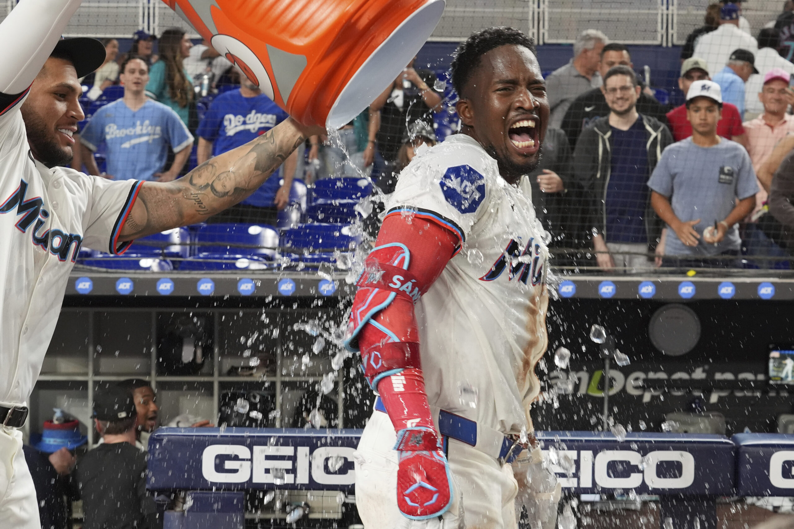 Miami Marlins catcher Agustín Ramírez, left, pours ice water on...
