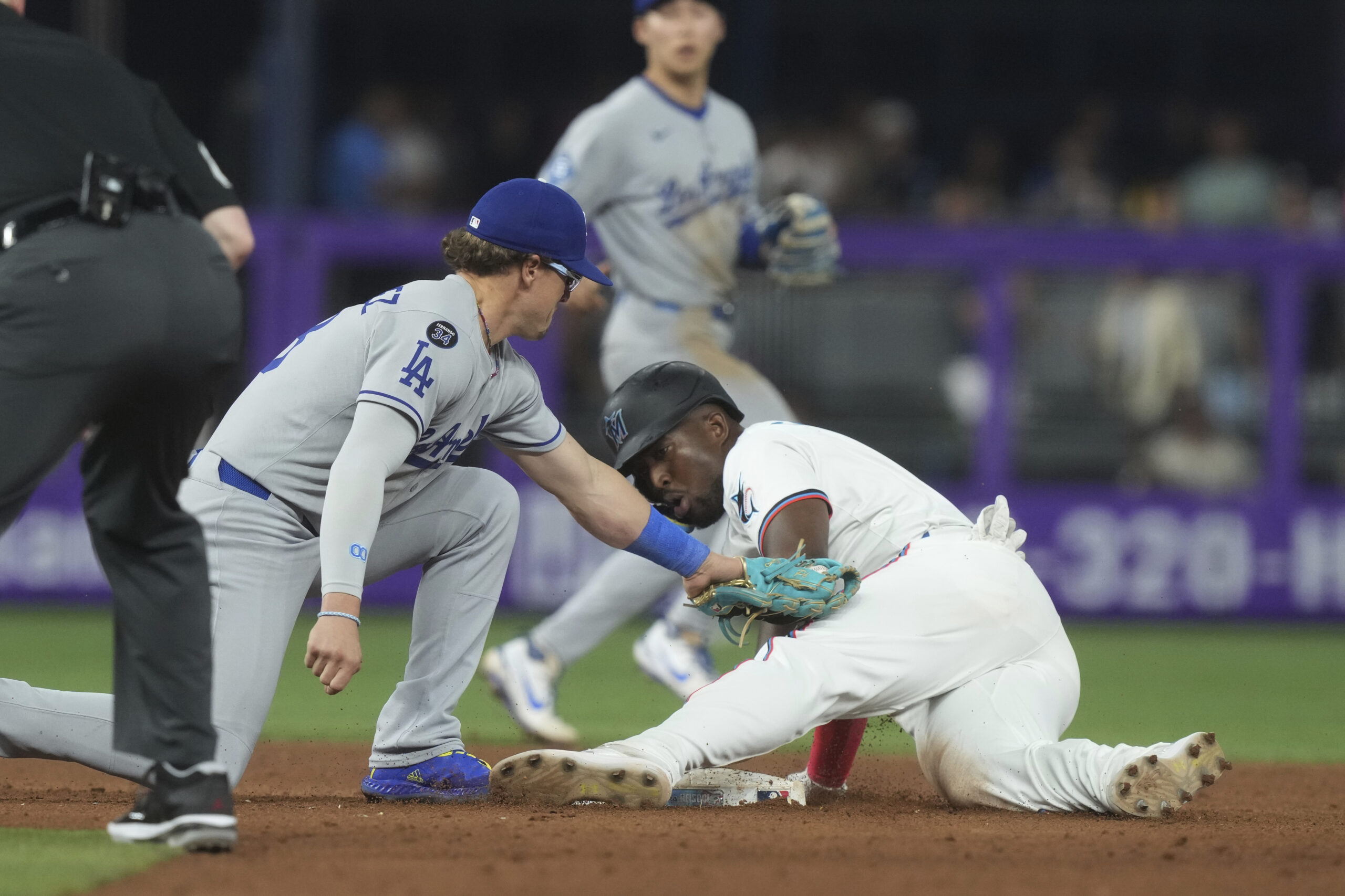 The Miami Marlins’ Jesús Sánchez steals second base as Dodgers...