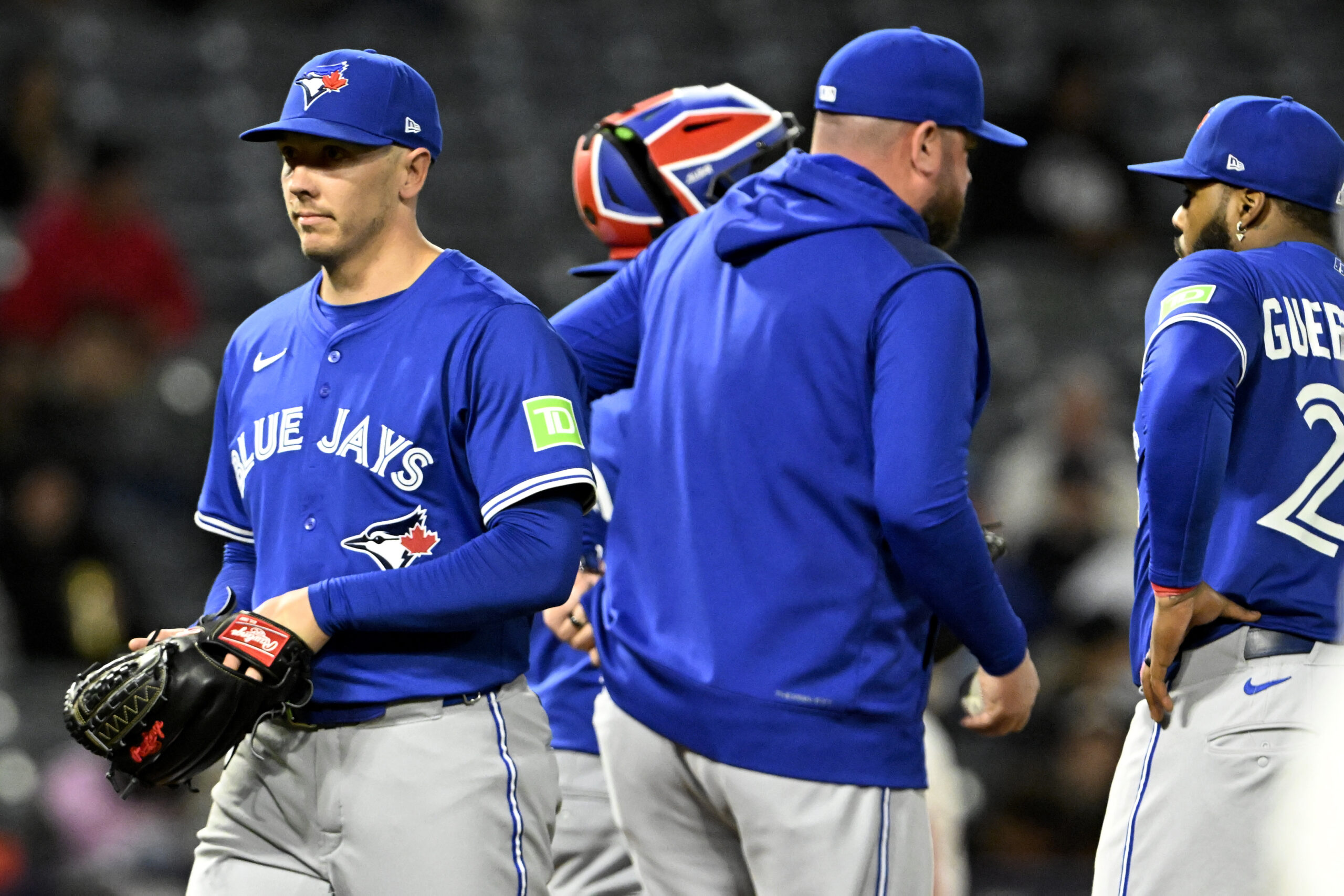 Toronto Blue Jays relief pitcher Chad Green, left, is removed...