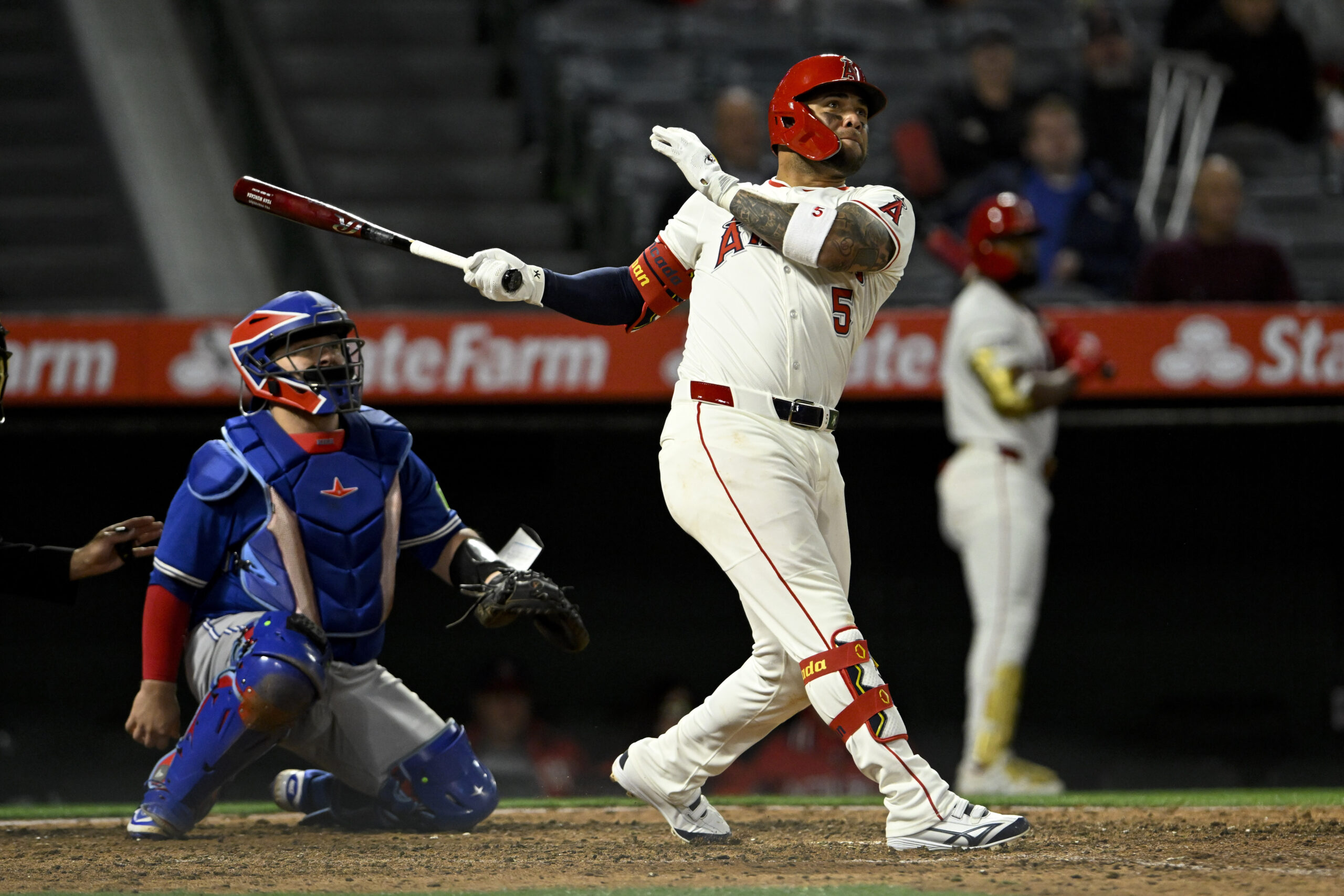 The Angels’ Yoan Moncada watches the flight of his three-run...
