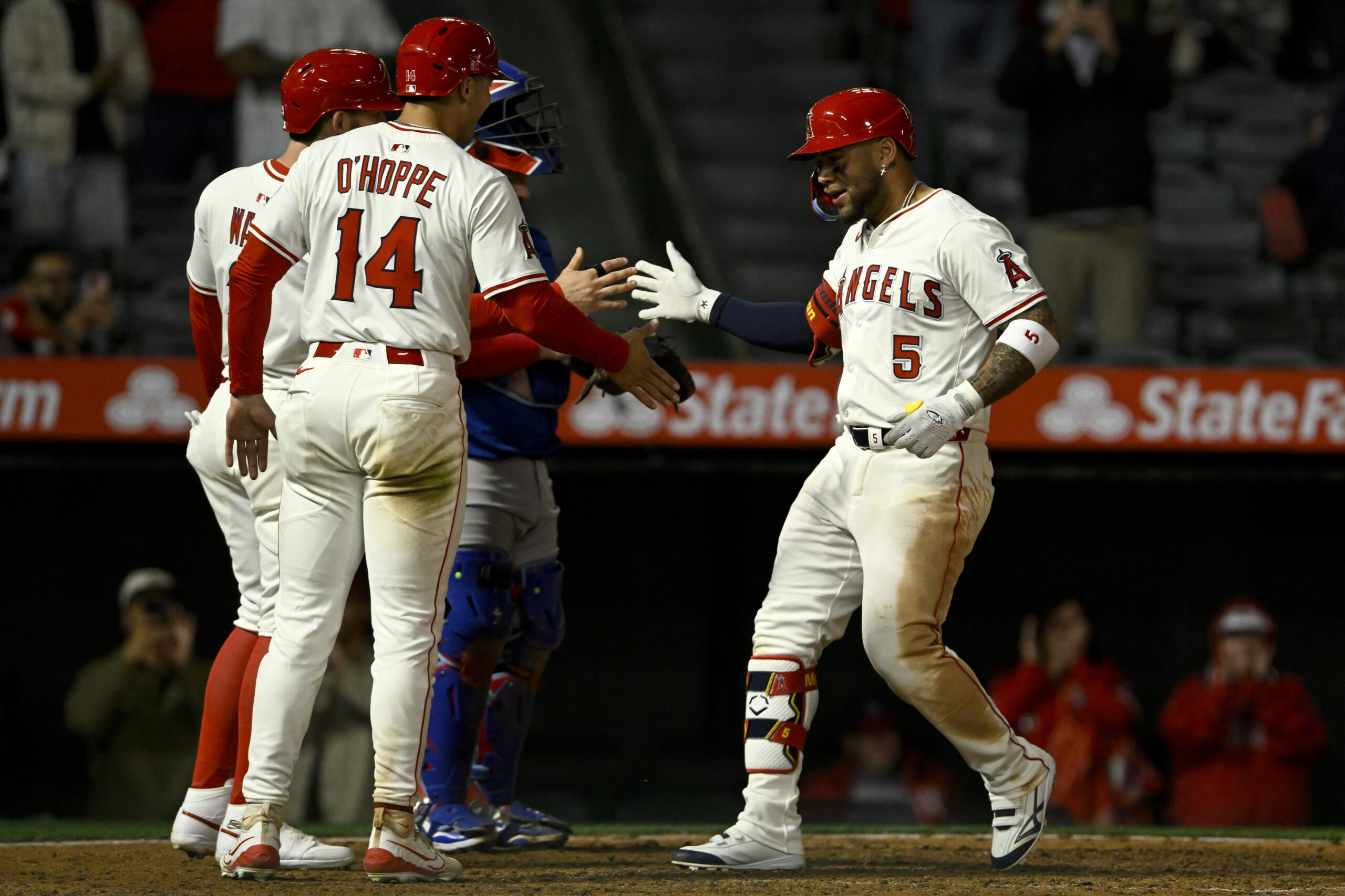 The Angels’ Yoan Moncada, right, celebrates at the plate with...