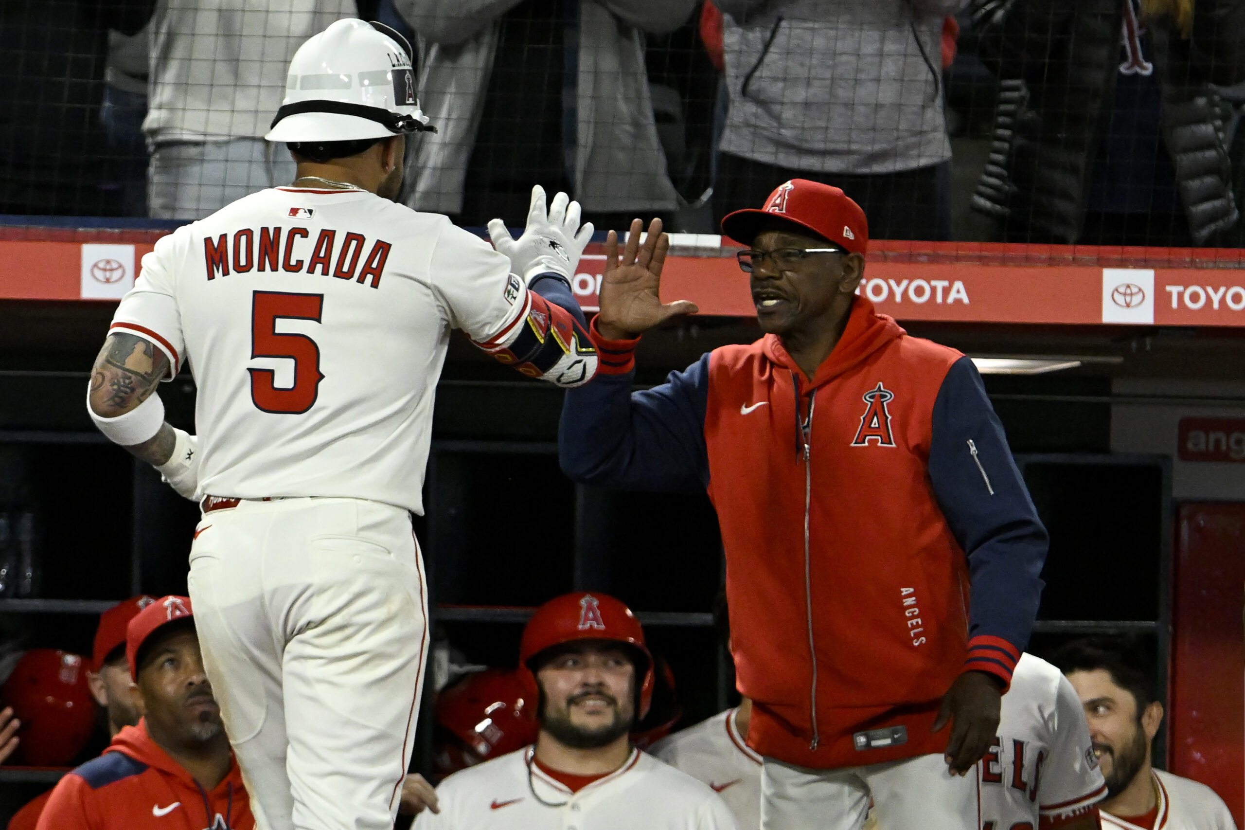 The Angels’ Yoan Moncada, left, celebrates with Manager Ron Washington...