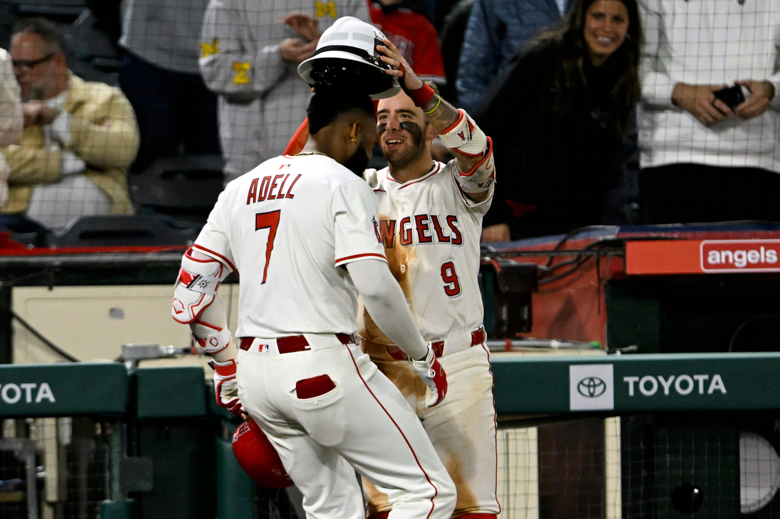 Angels shortstop Zach Neto, right, crowns Jo Adell with the...