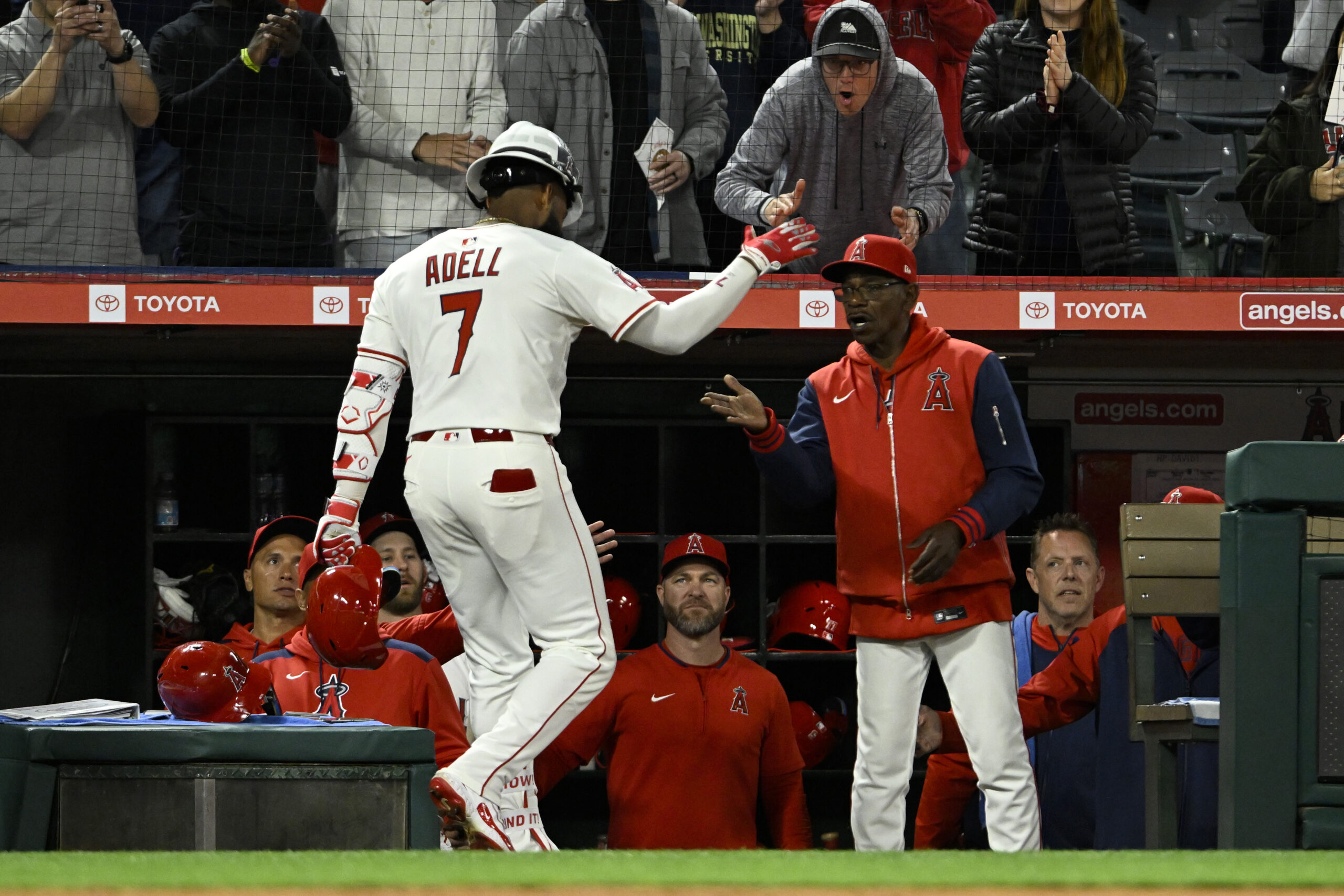 Angels manager Ron Washington, right, greets Jo Adell as he...