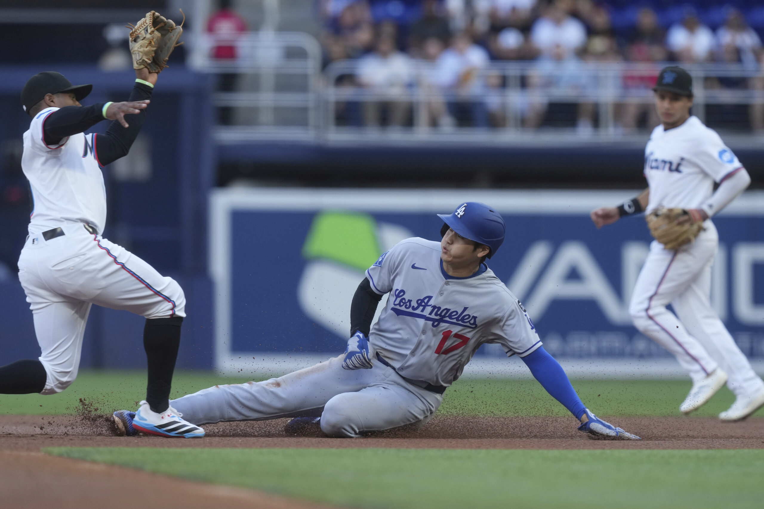 The Miami Marlins’ Xavier Edwards takes a throw before tagging...