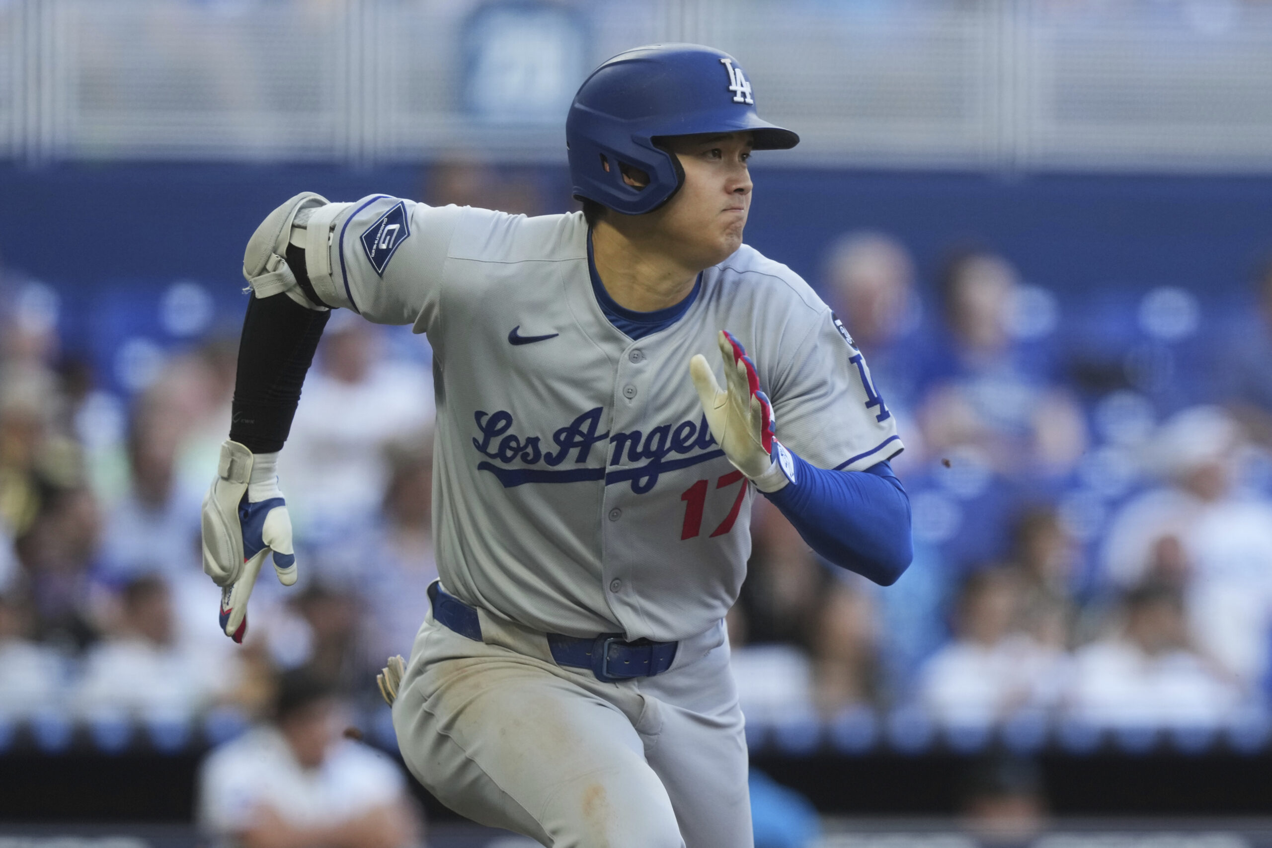 Dodgers star Shohei Ohtani runs after hitting a triple during...
