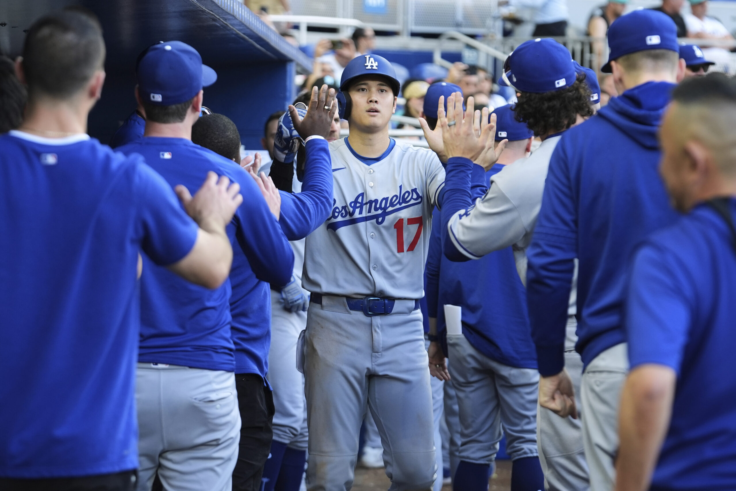 Dodgers star Shohei Ohtani celebrates after scoring on a hit...
