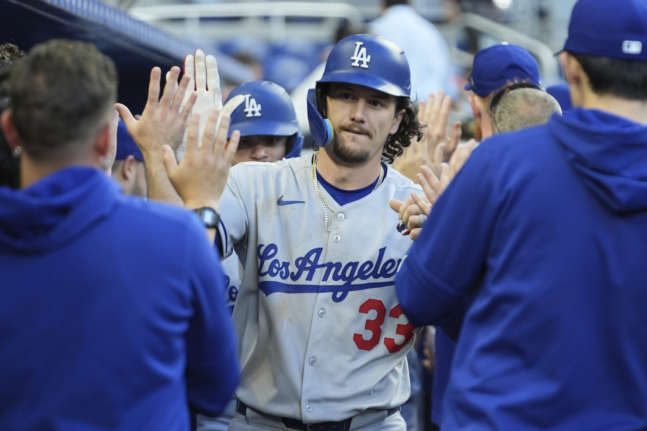 The Dodgers’ James Outman celebrates in the dugout after hitting...