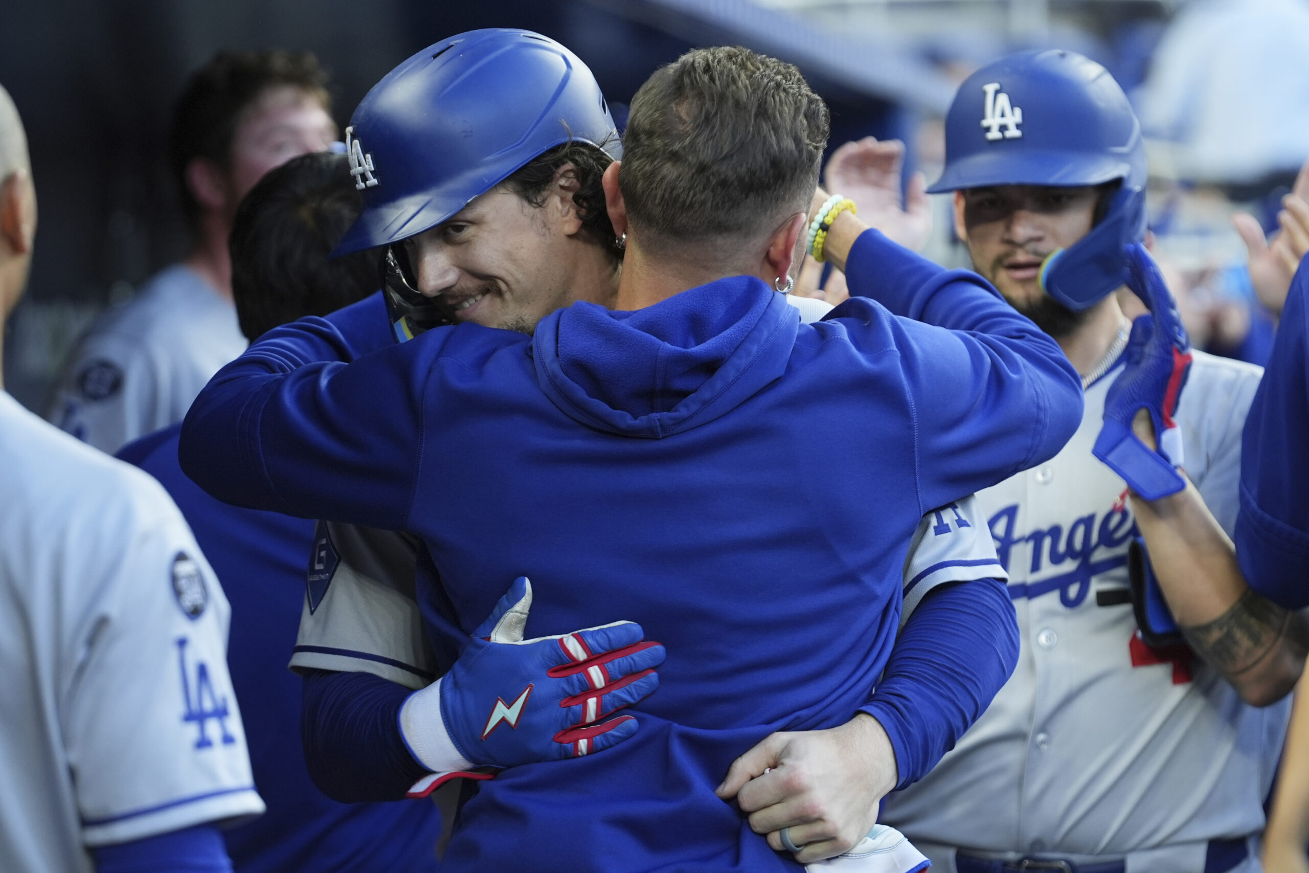 The Dodgers’ James Outman, left, is hugged by teammate Miguel...