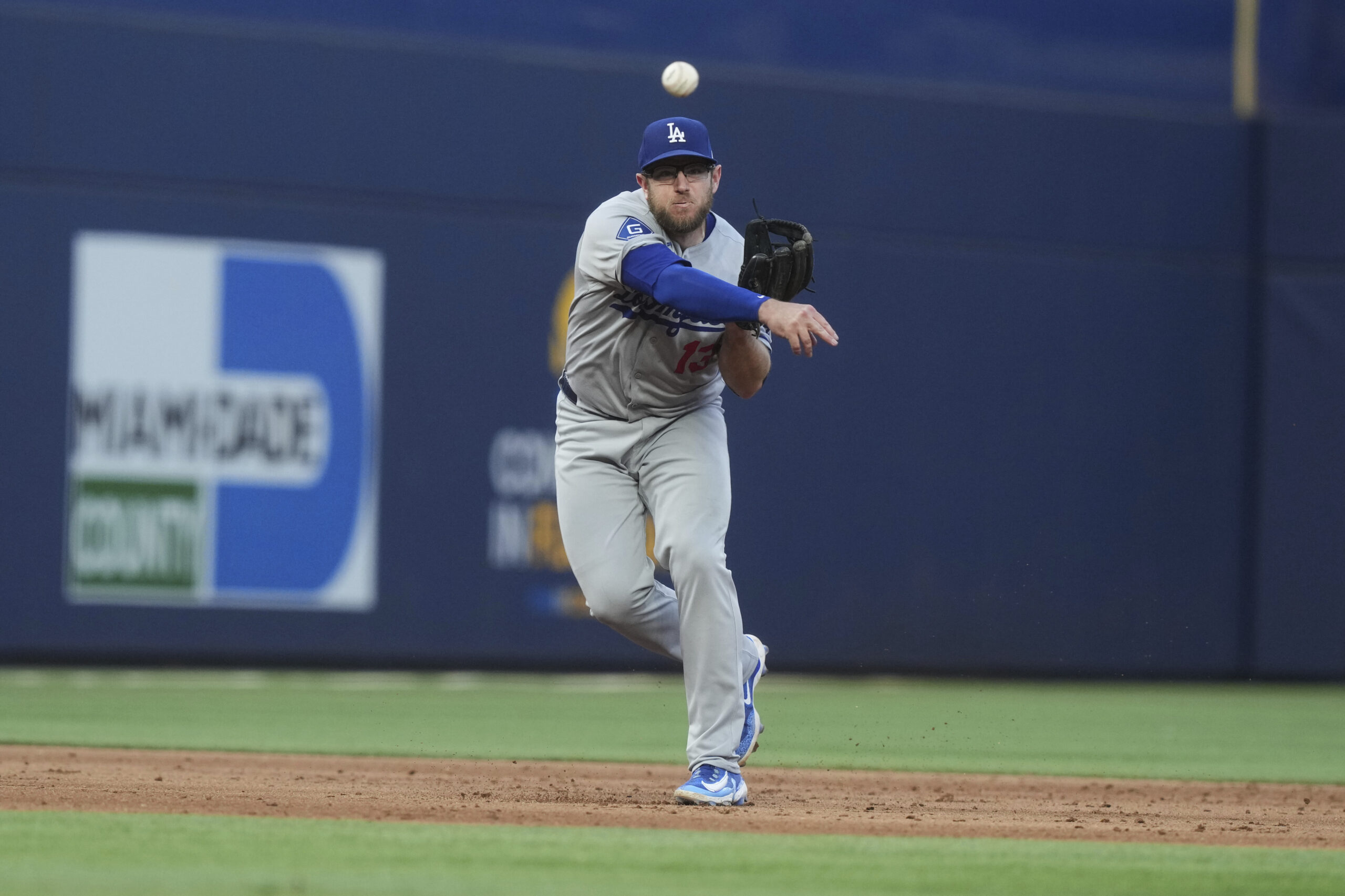 Dodgers third base Max Muncy throws to first base during...