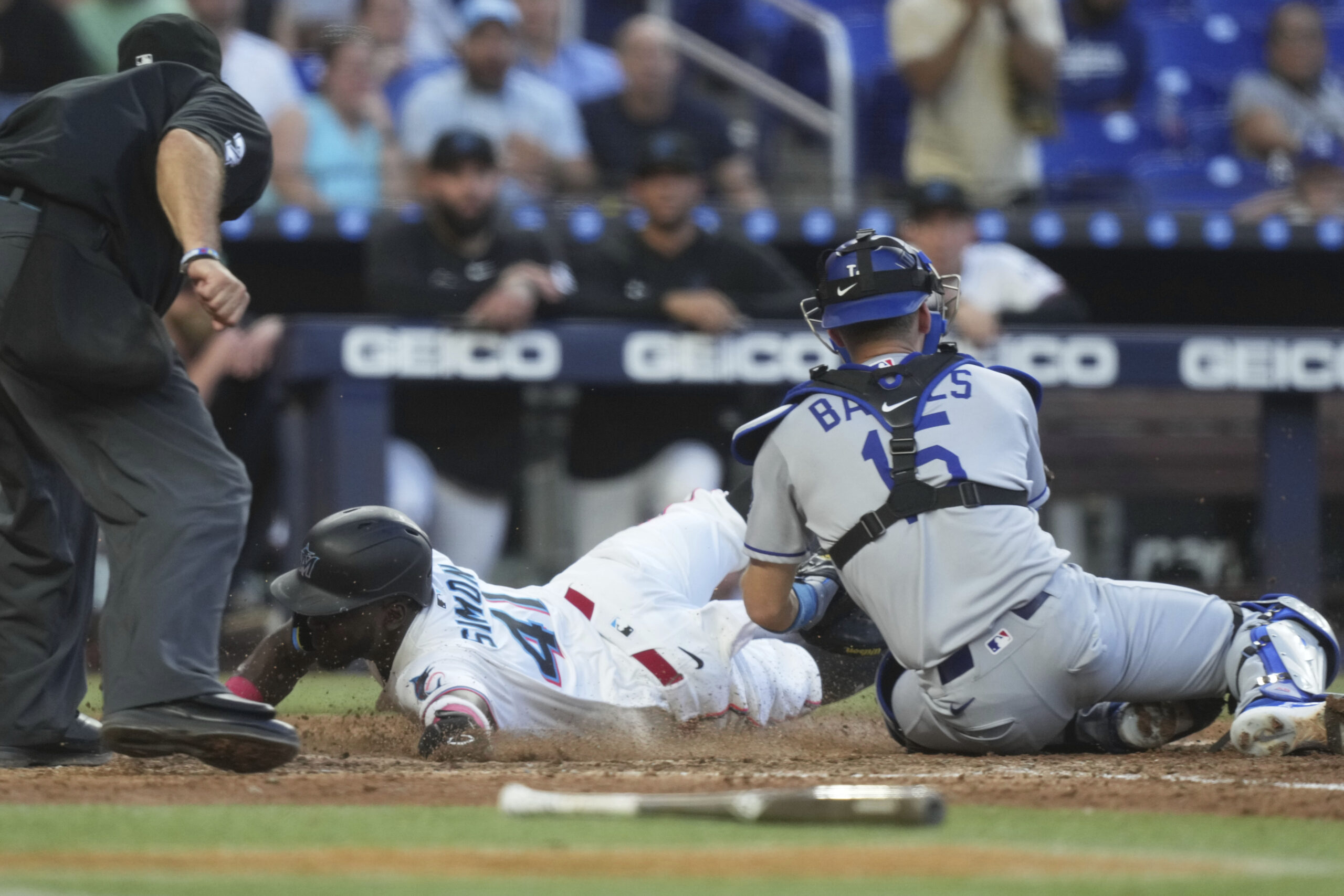 The Miami Marlins’ Ronny Simon slides into home plate to...