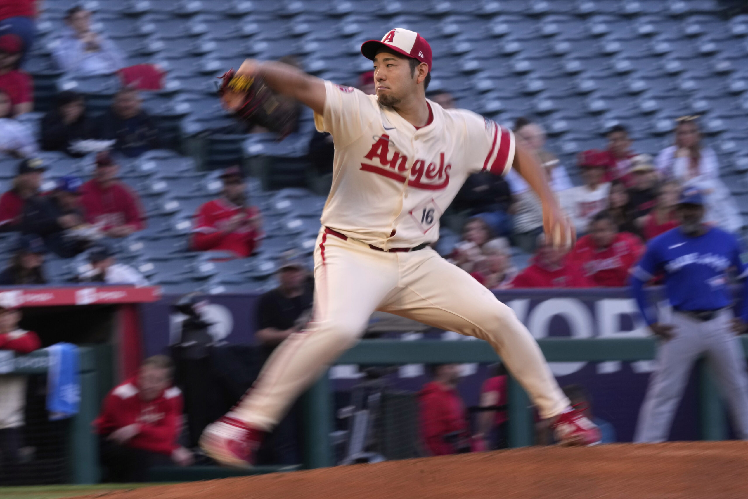 Angels starting pitcher Yusei Kikuchi throws to the plate during...