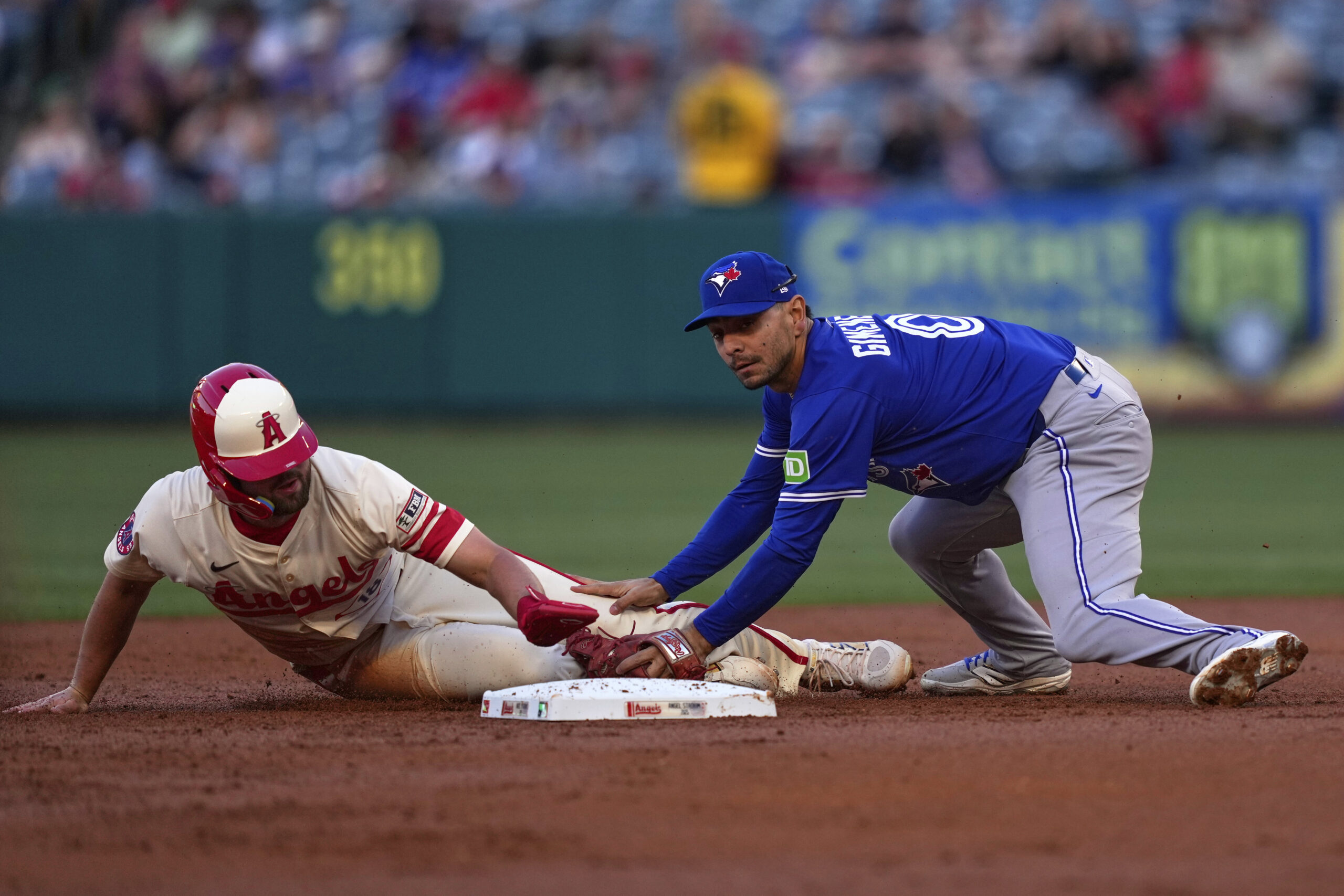 The Angels’ Nolan Schanuel, left, is tagged out by Toronto...