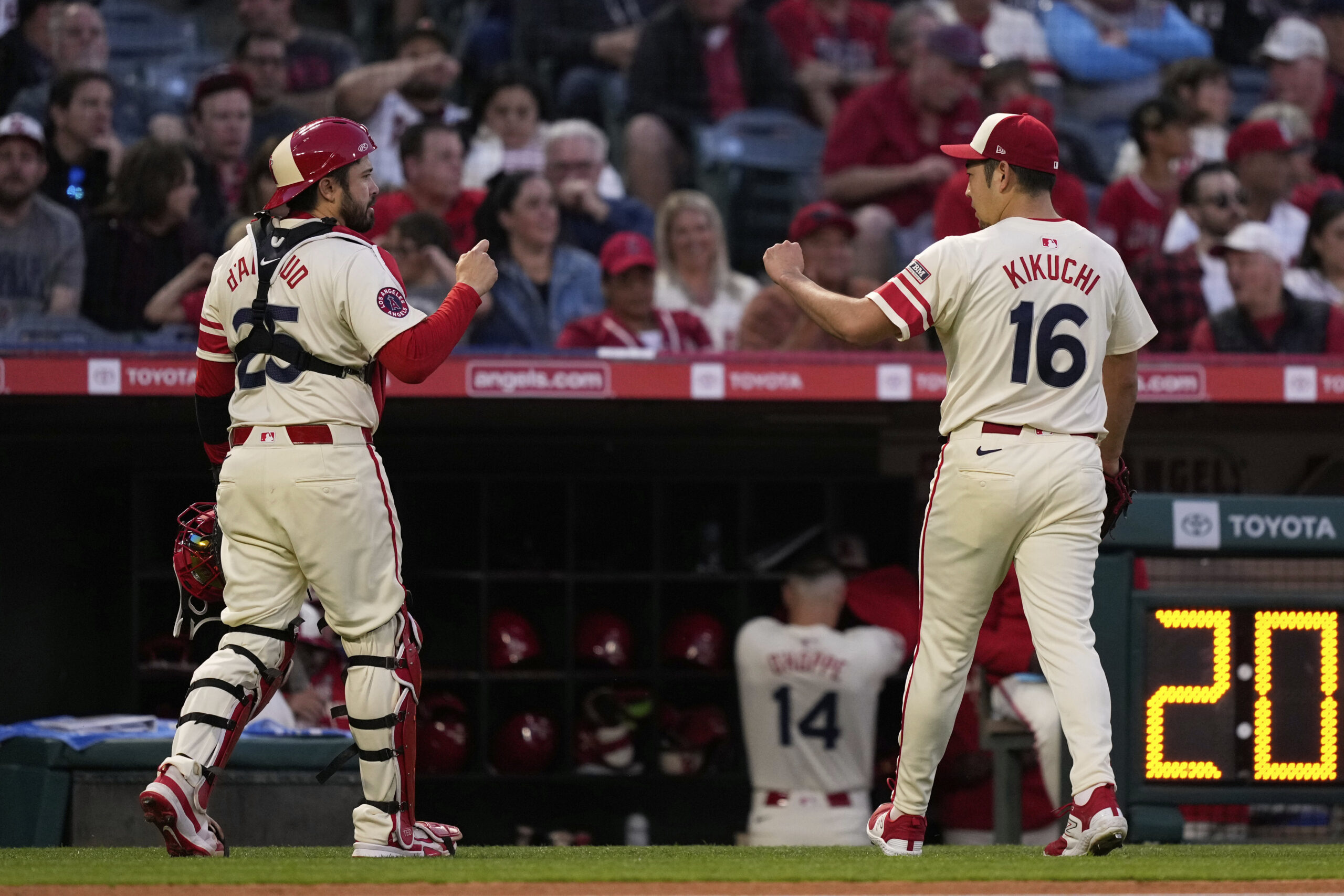 Angels catcher Travis d’Arnaud, left, and starting pitcher Yusei Kikuchi...