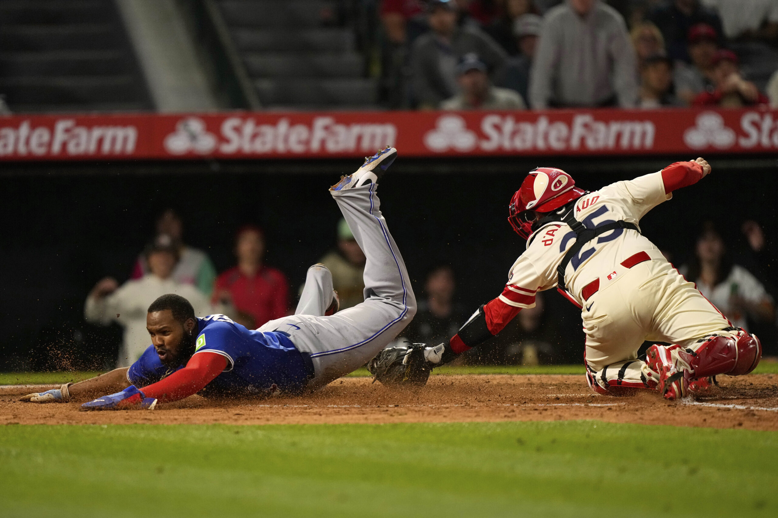 The Toronto Blue Jays’ Vladimir Guerrero Jr., left, scores under...