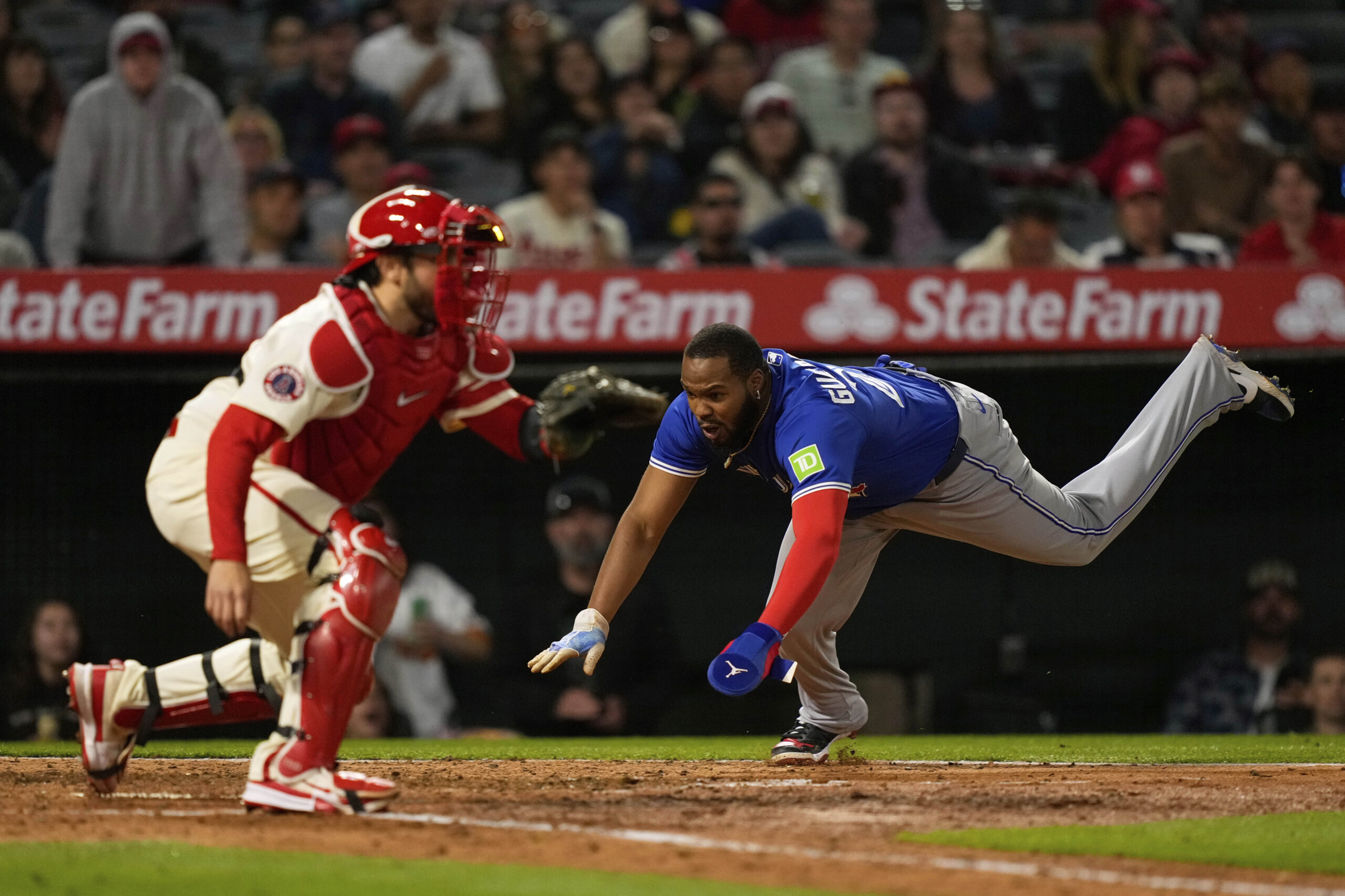 The Toronto Blue Jays’ Vladimir Guerrero Jr., right, scores on...