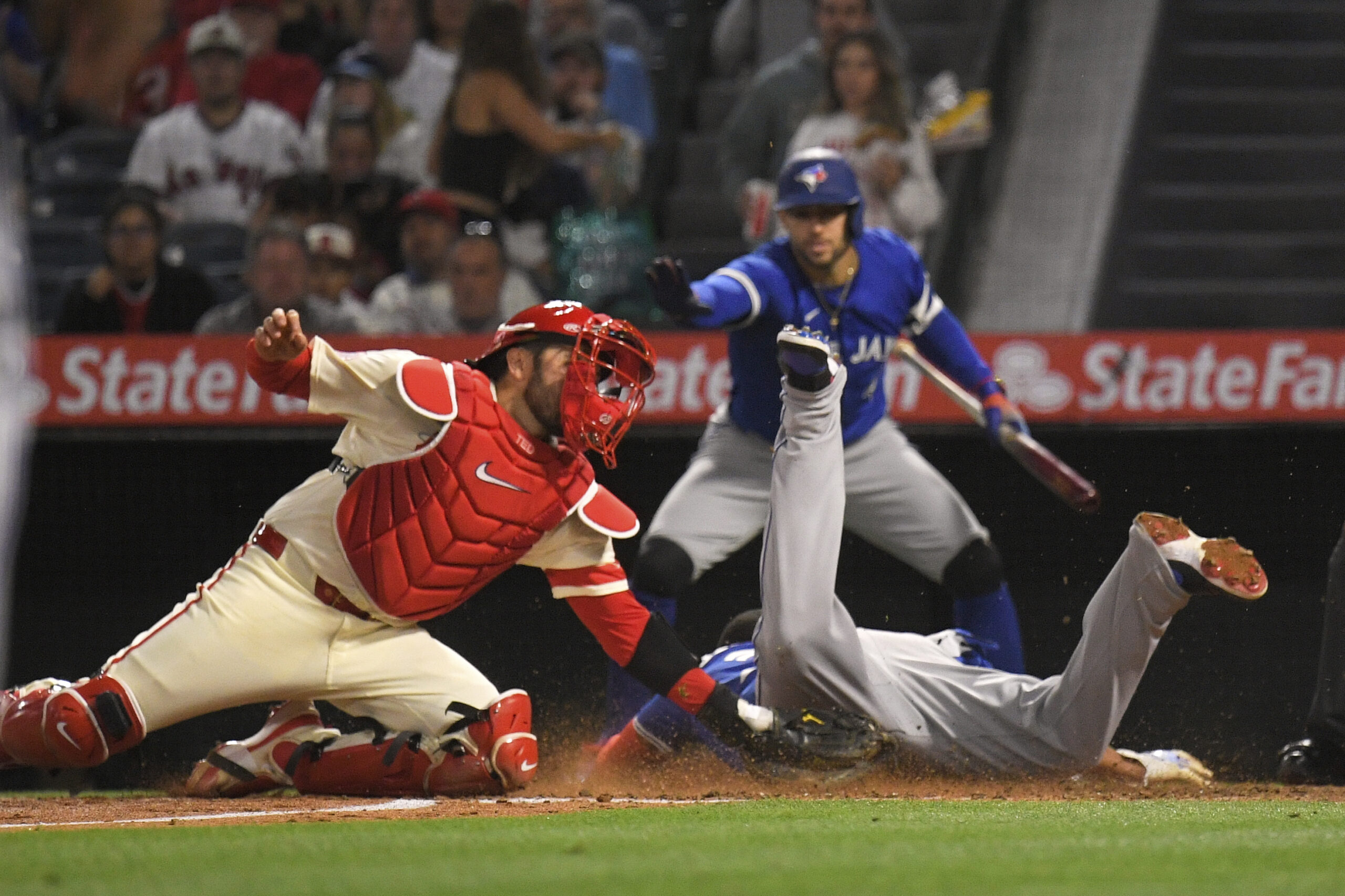 The Toronto Blue Jays’ Vladimir Guerrero Jr., right, scores on...